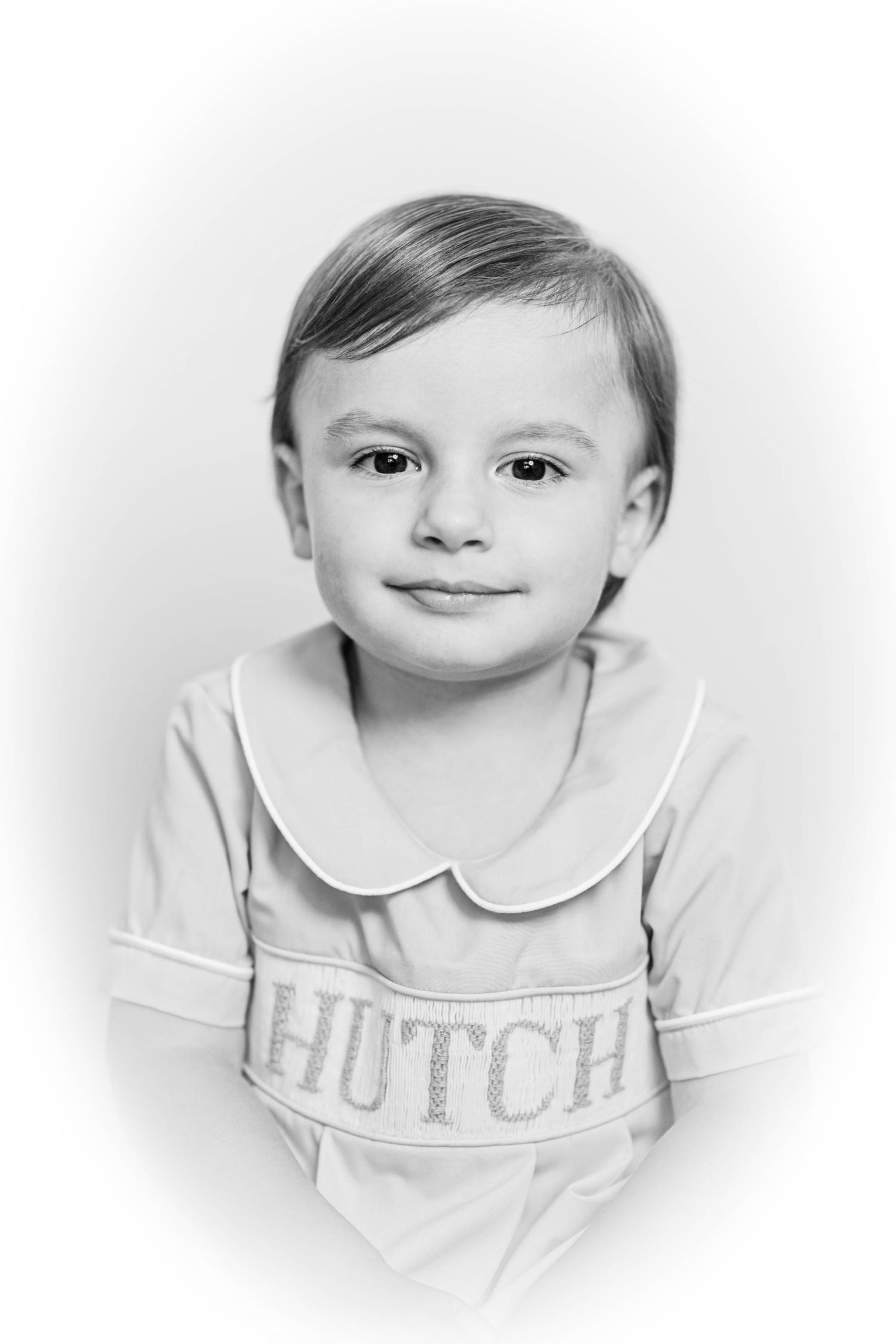 Black and white portrait of a young boy named Hutch wearing a light-colored Peter Pan collar shirt.
