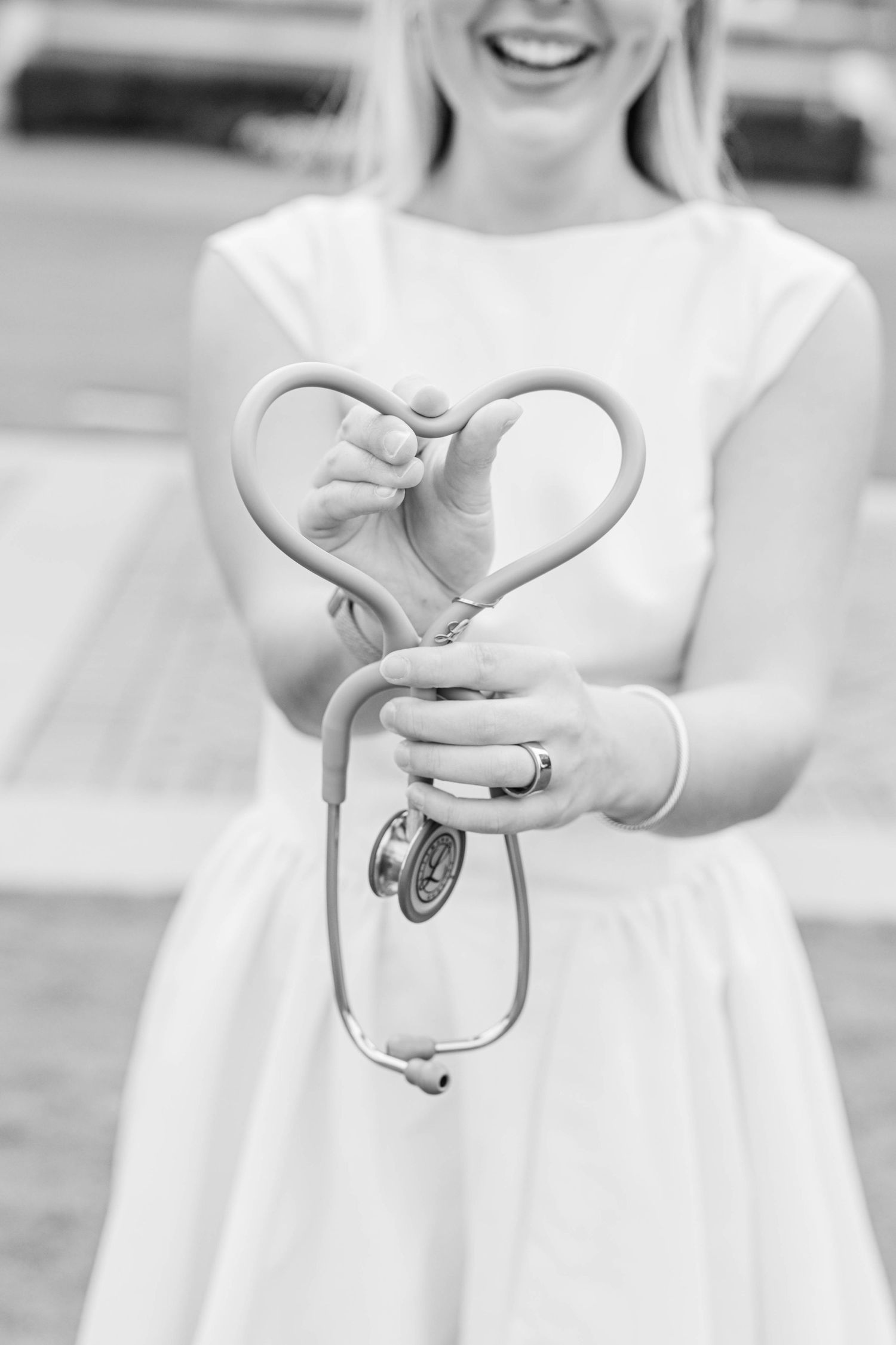 Hands forming heart shapes shown in black and white photography.