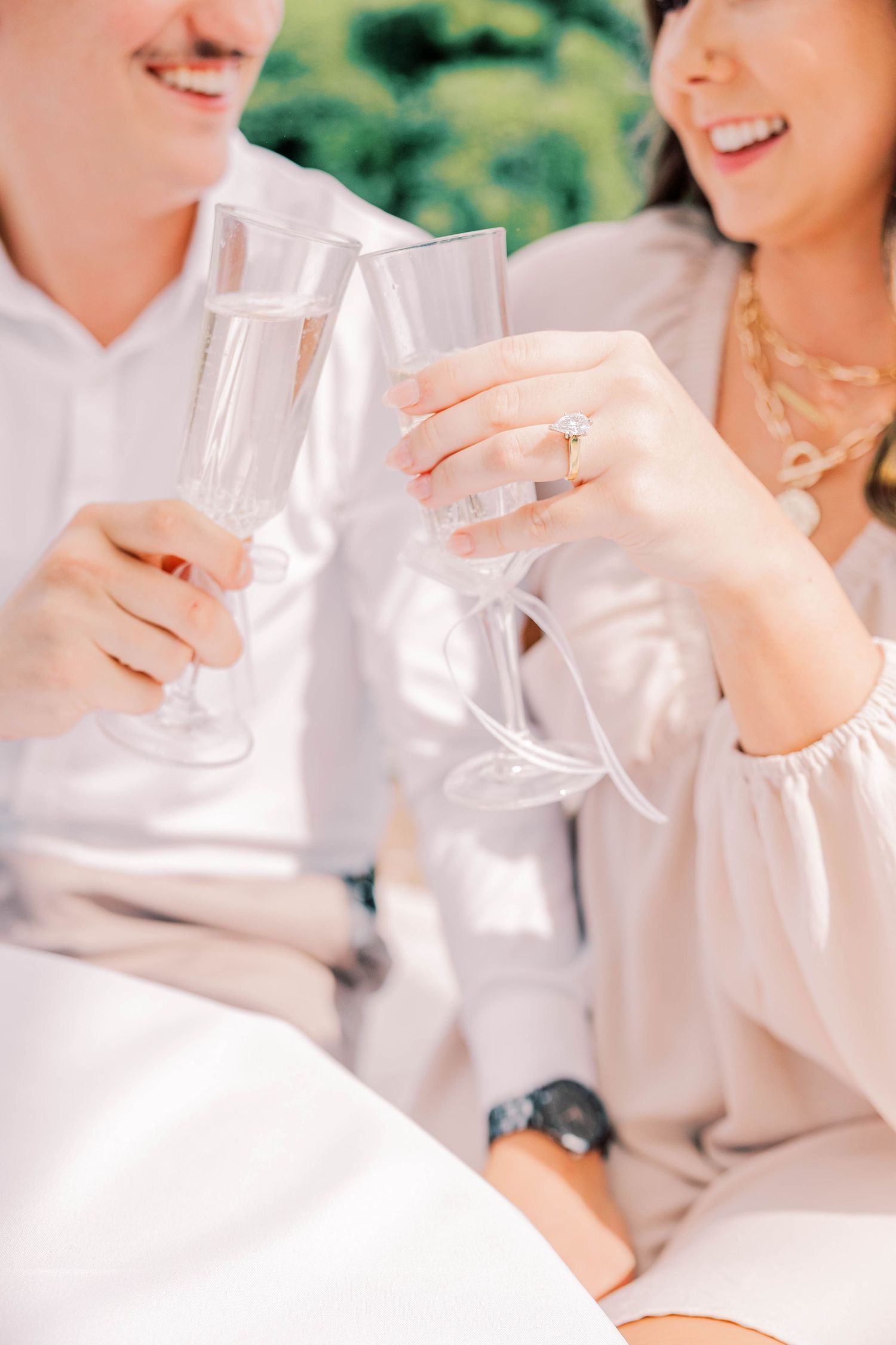 Close-up of hands holding champagne glasses in celebration.