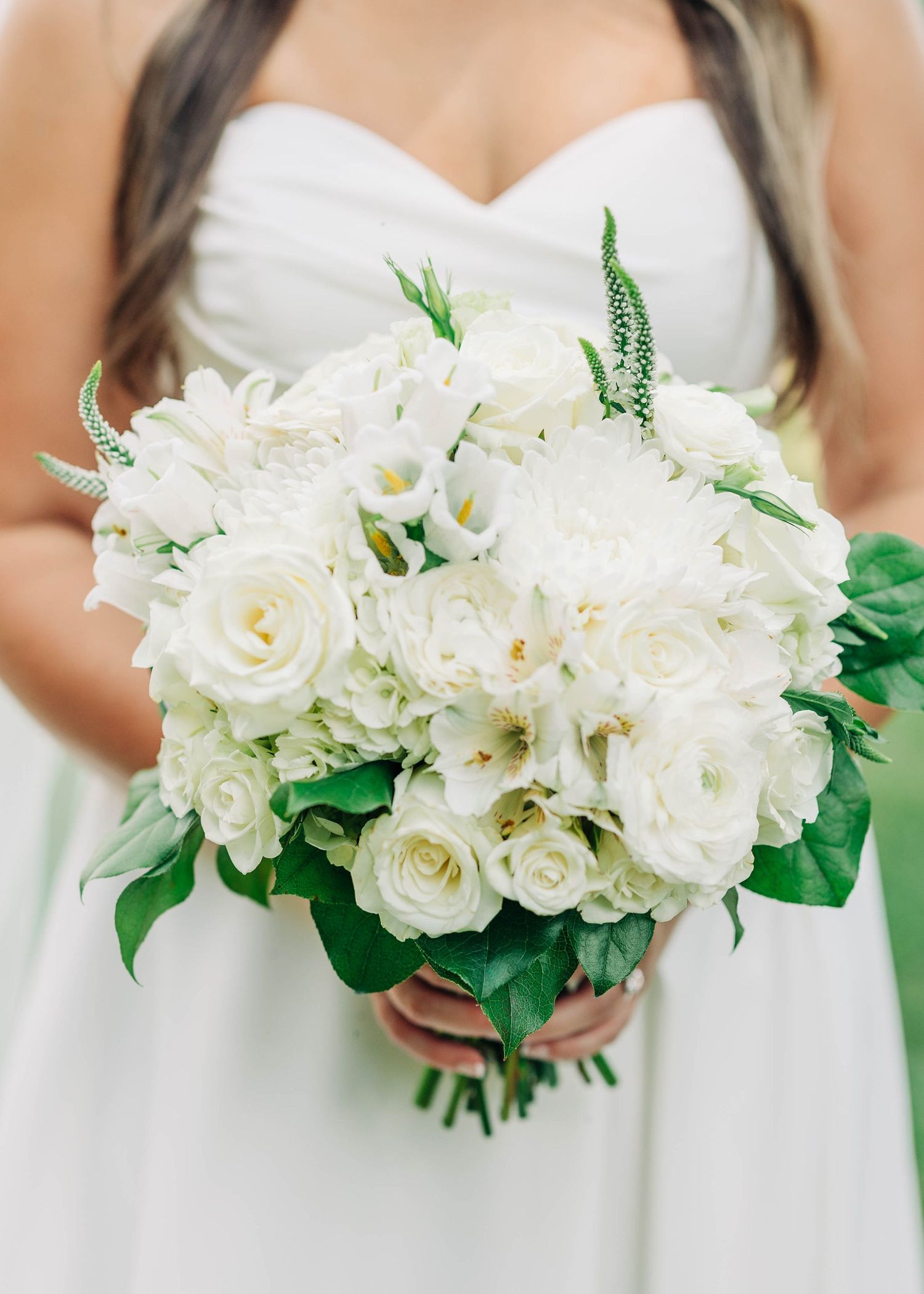 Classic white rose and gardenia bouquets with lush green foliage.