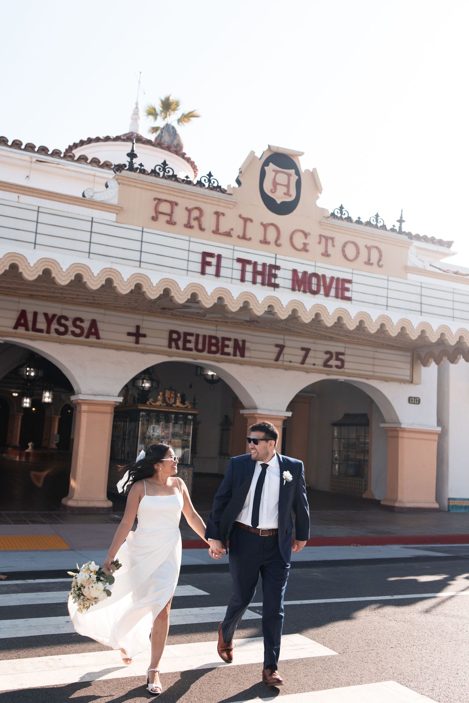 A couple poses playfully in front of an art deco style movie theater marquee in a series of romantic wedding photos.