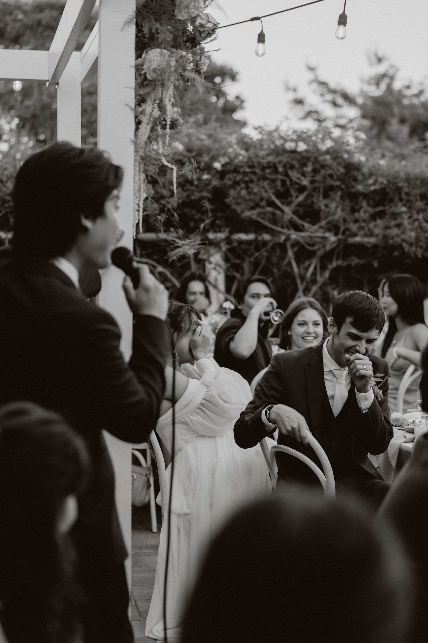Black and white photo sequence showing people at an outdoor gathering with string lights visible overhead.