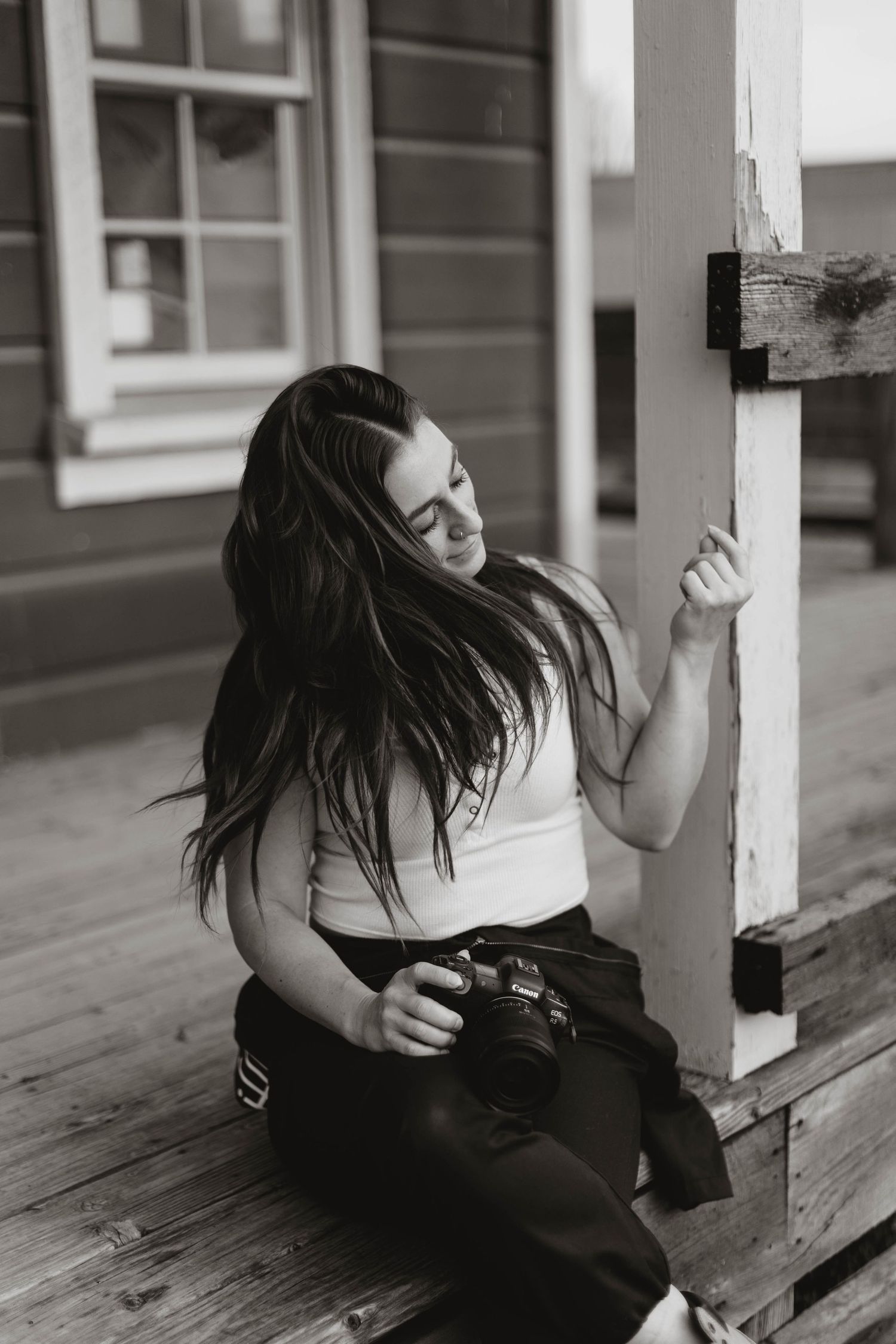 A series of black and white photos showing a person in dark clothing leaning against a wooden porch post.