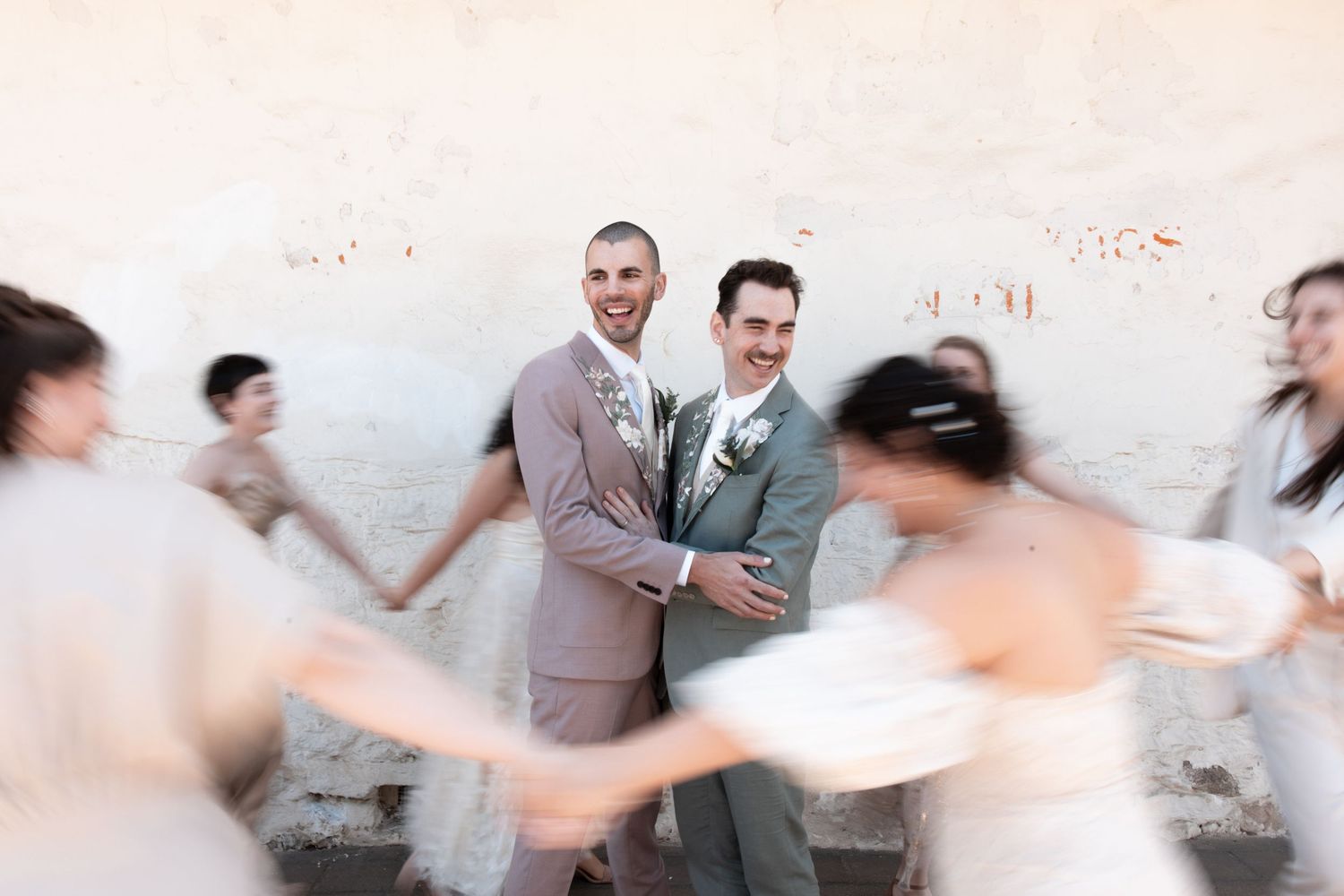 A sequence of motion blur images showing people dancing together in a white room.