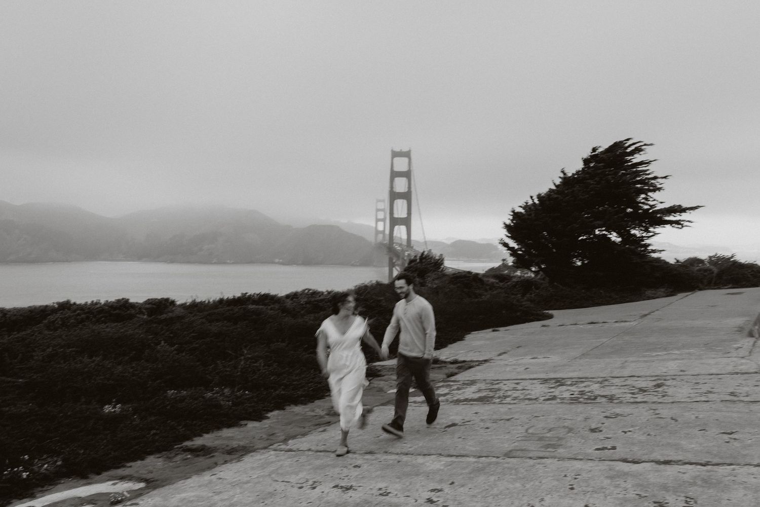 A series of black and white photos showing people walking near the Golden Gate Bridge on a foggy San Francisco day.