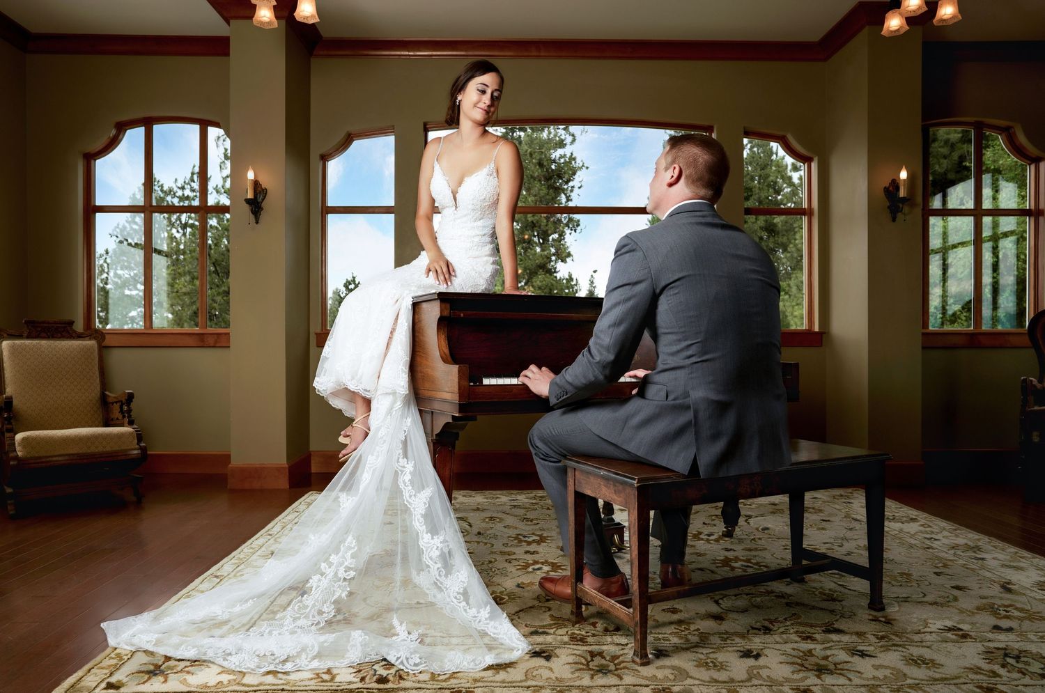 An elegant wedding moment captured with a bride and pianist at a grand piano in a sunlit room.