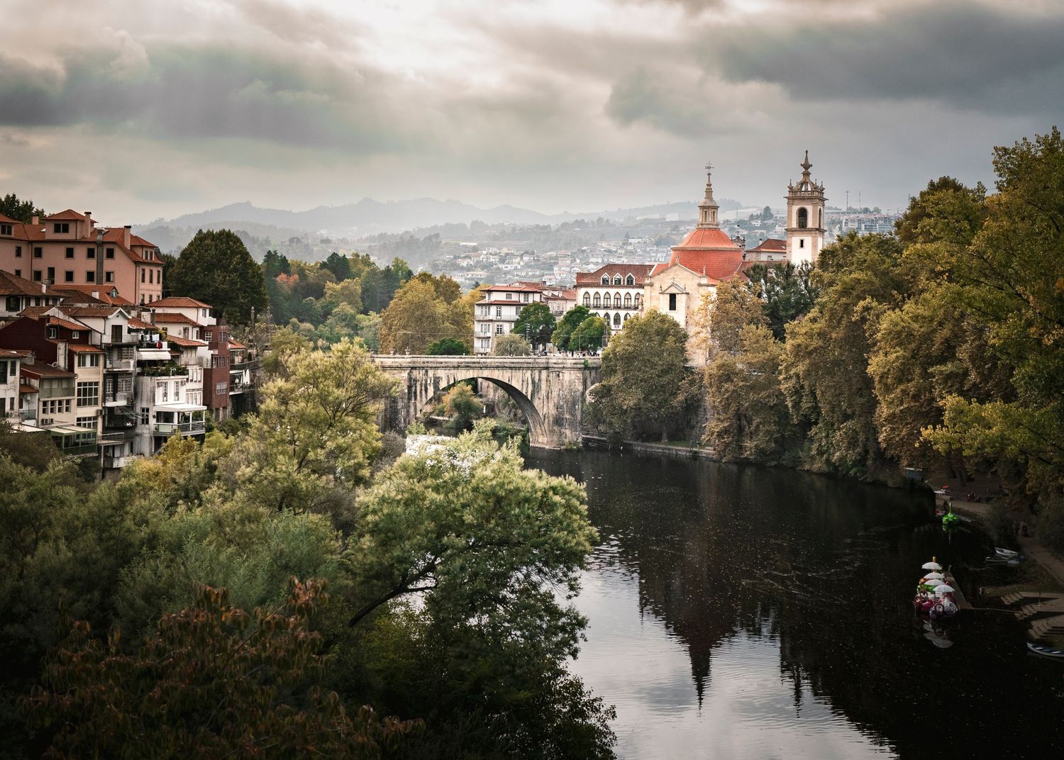 Scenic riverside view of historic buildings and church domes in Porto, Portugal.