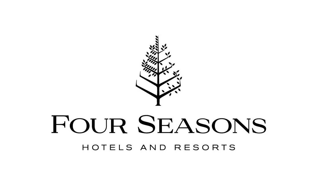 Black and white Four Seasons Hotels logo featuring geometric tree design and text.