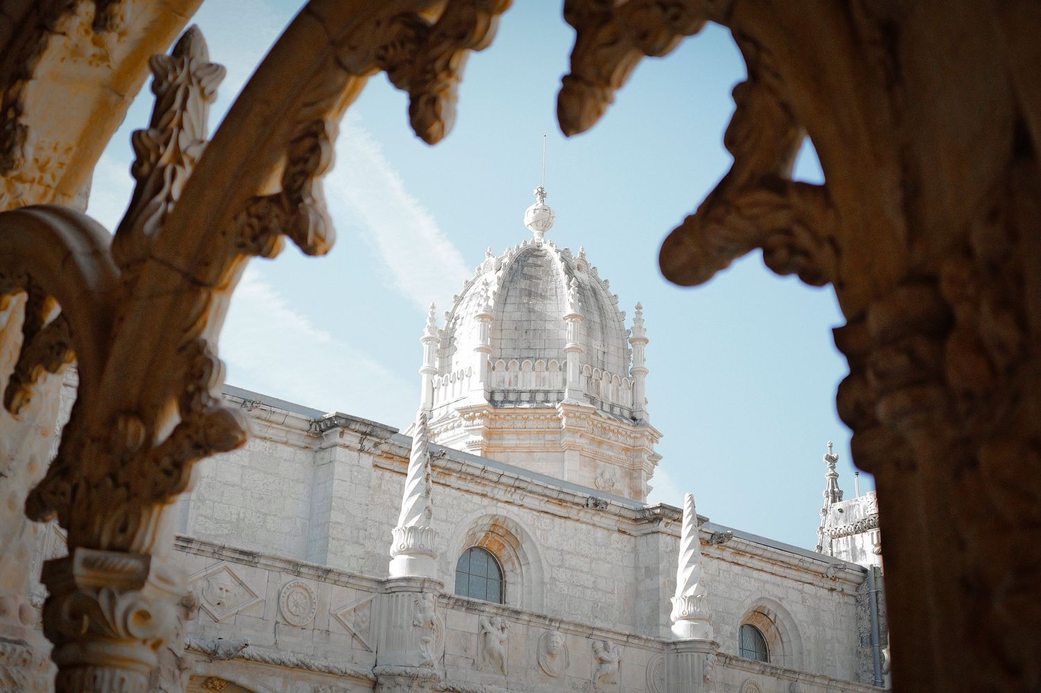 Ornate Gothic stone archways and architectural details of a historic cathedral cloister.