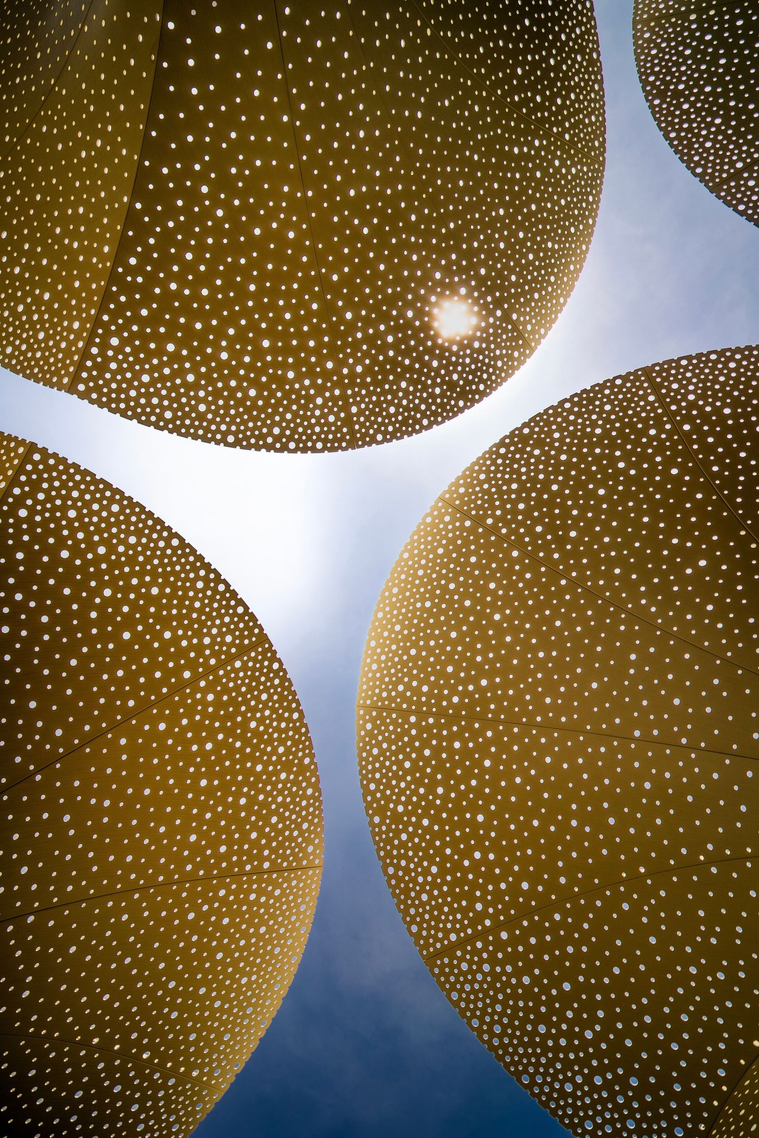Decorative sun shade perforated gold domes creating a starry effect.