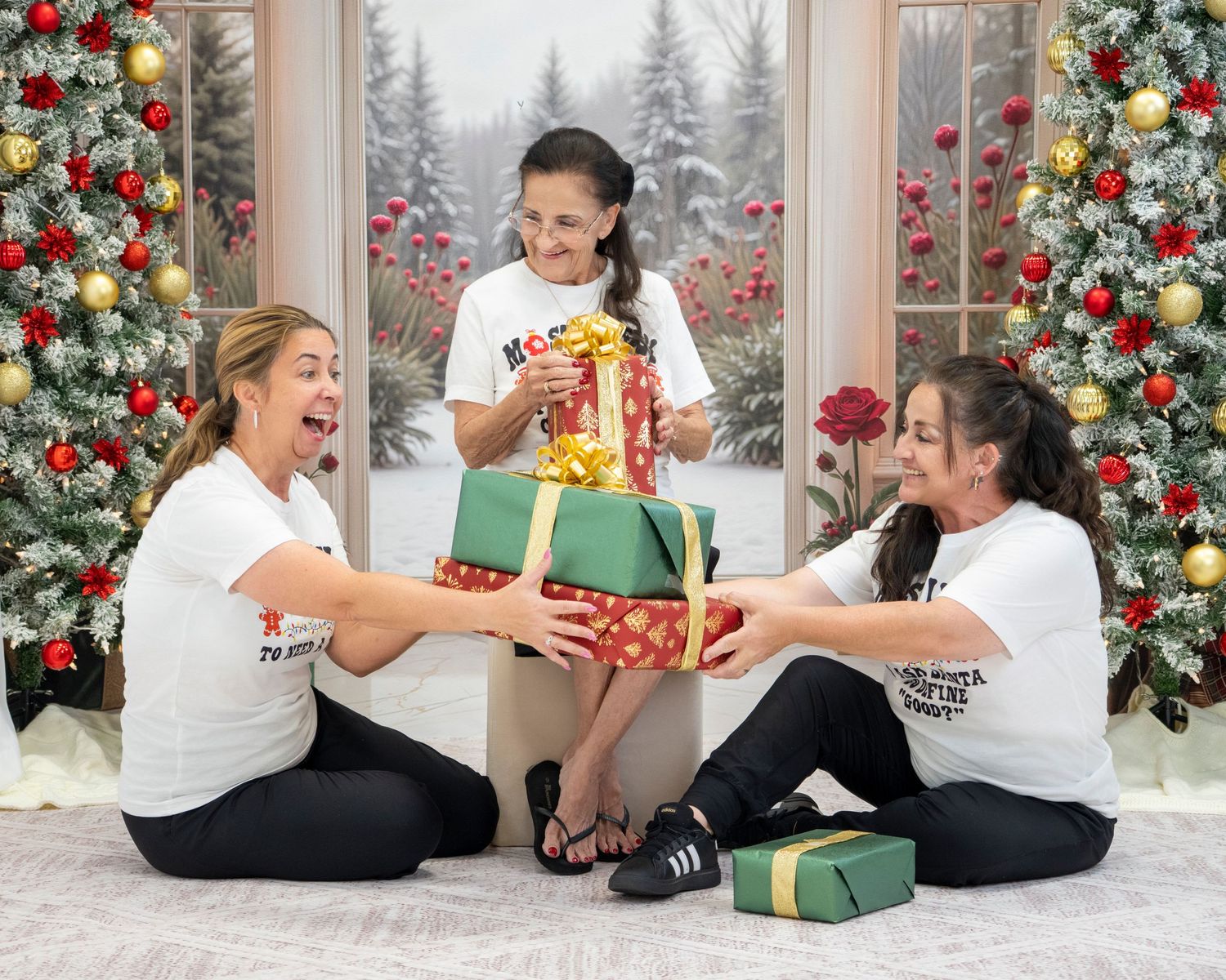Three girls in white shirts exchange Christmas gifts beside decorated holiday trees in a festive snowy scene.