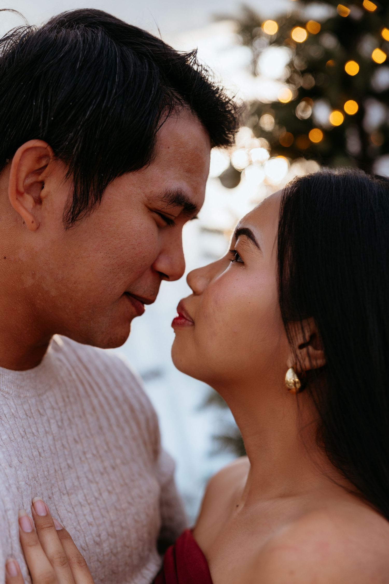 A romantic couple shares intimate moments in a series of close-up shots with twinkling lights in the background.