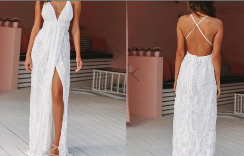 White eyelet lace maxi dress with thigh-high slit and cross-back straps.