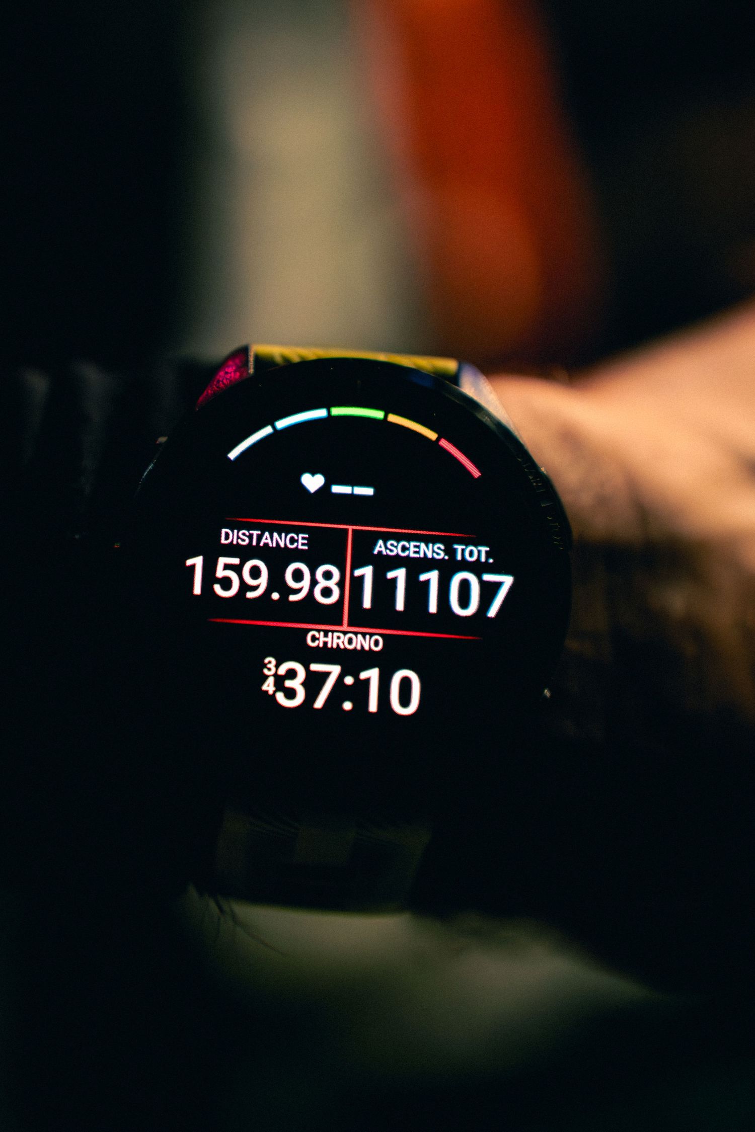GPS sports watch displaying 159.98km distance, 11107m elevation gain, and 37:10 race time.