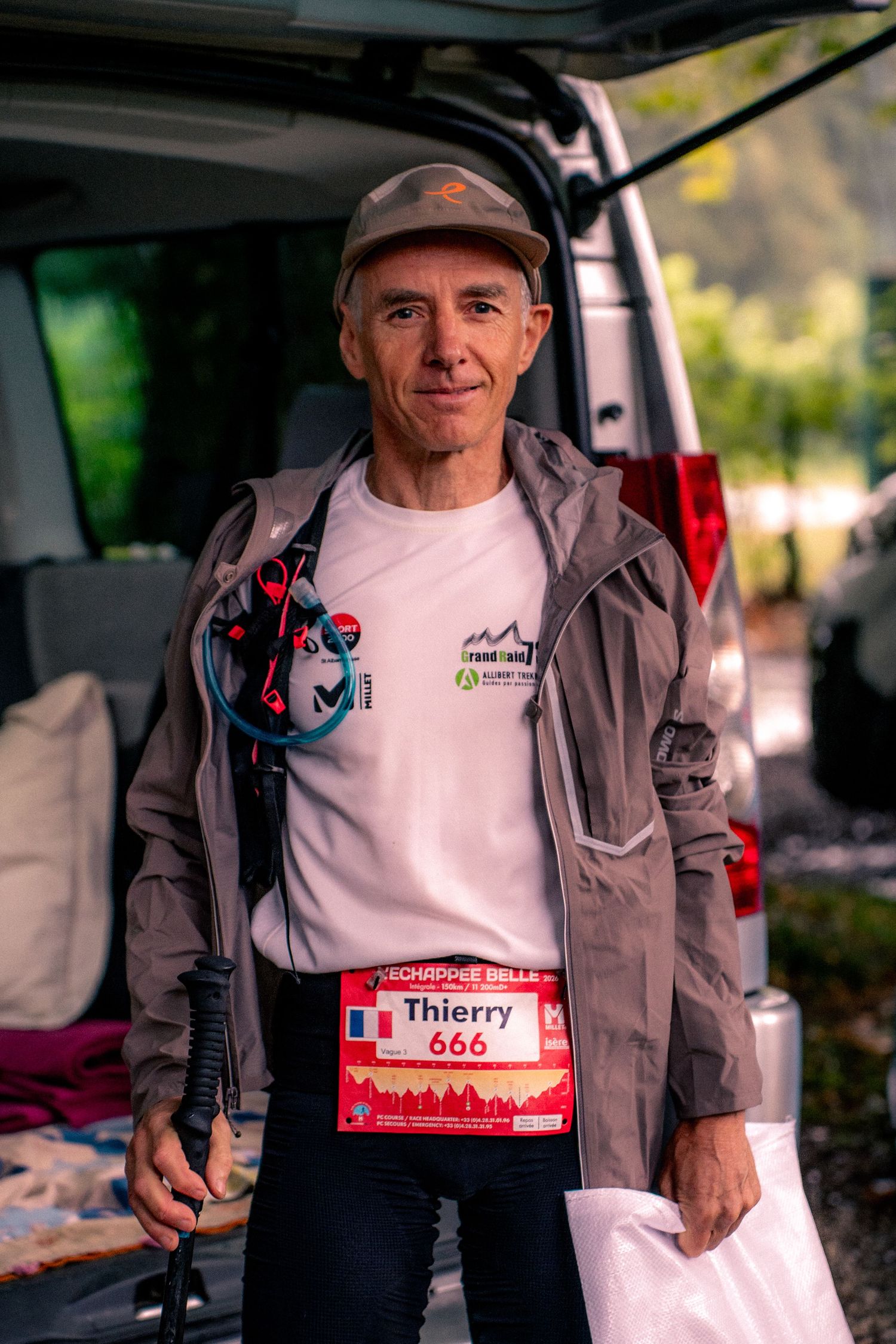 Trail runner Thierry bib 666 poses in gray jacket before mountain race.
