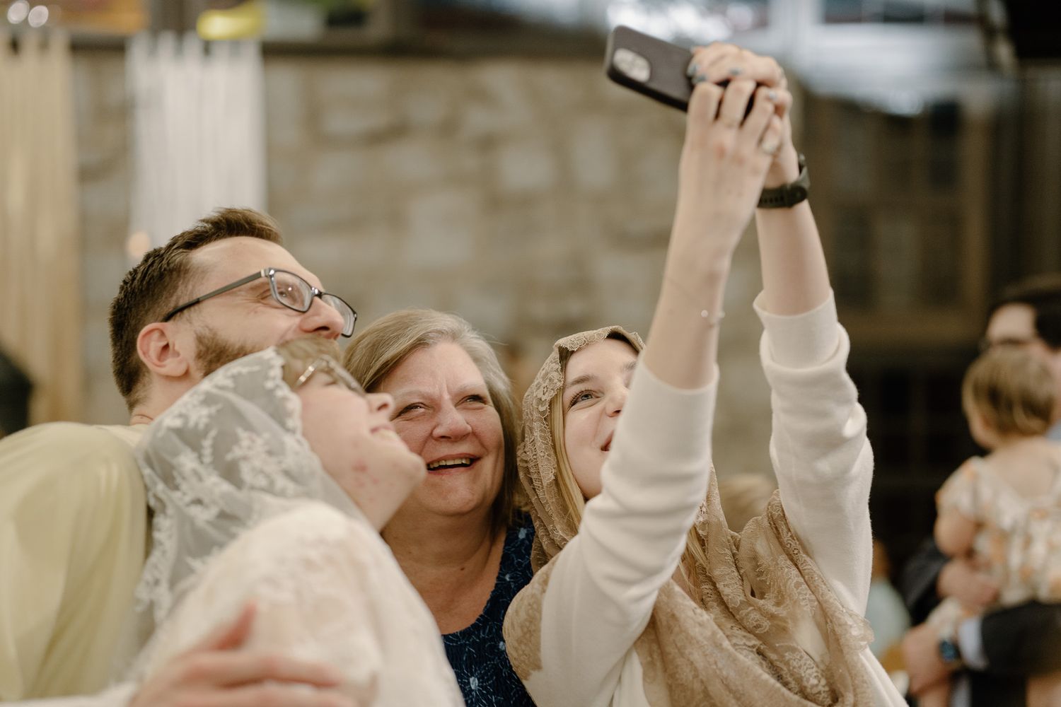 Group of people taking a joyful selfie together after a Catholic celebration of the Easter Vigil.