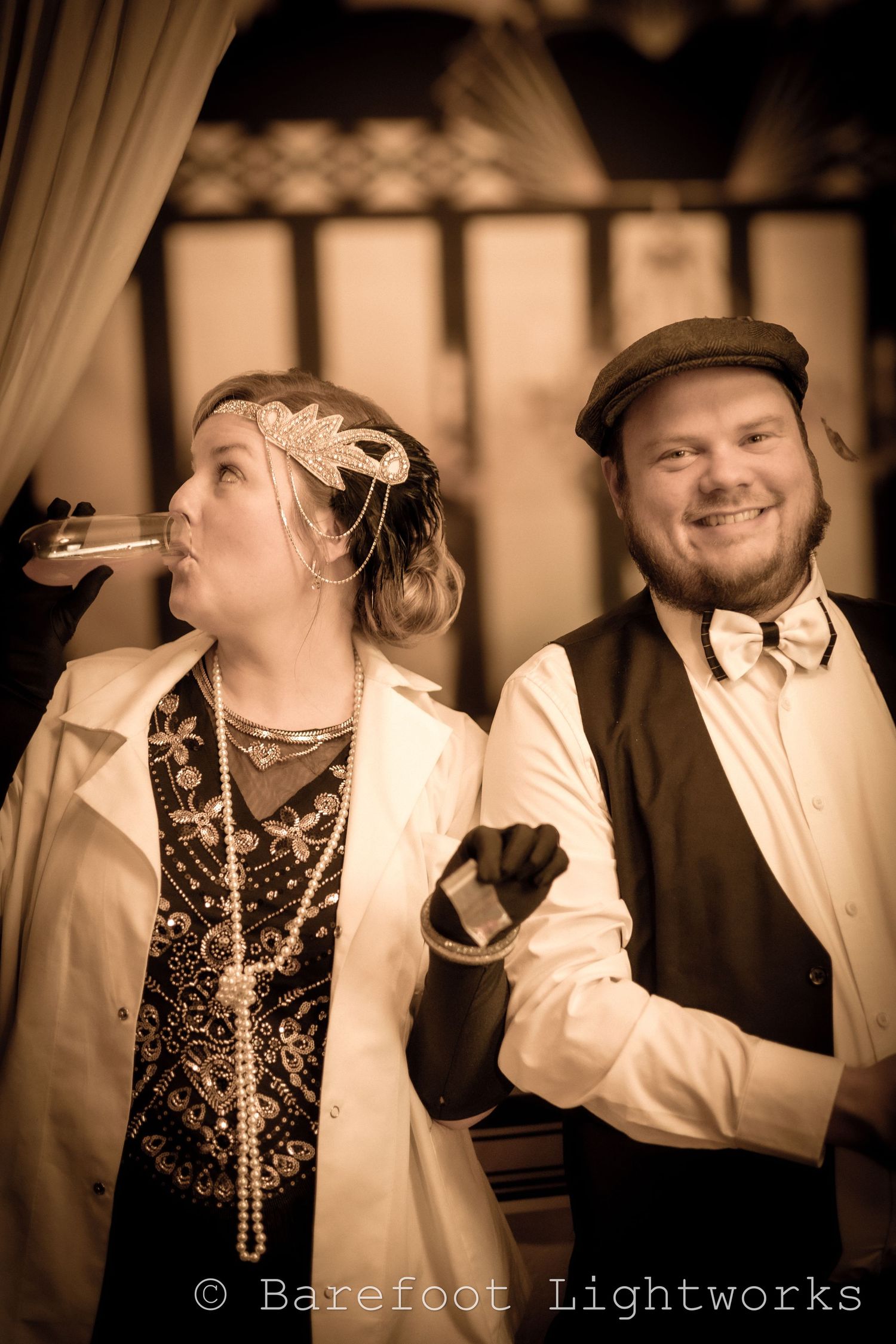 A photograph of a couple in a 1920's inspired outfit and filter. Roaring 20s.