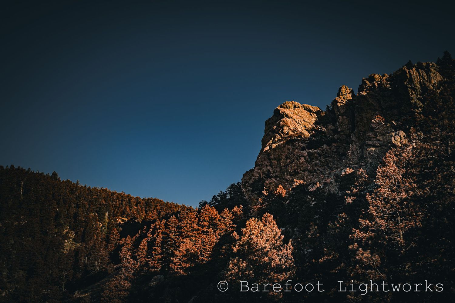 A landscape photo of Arthur's rock with a dark sky.