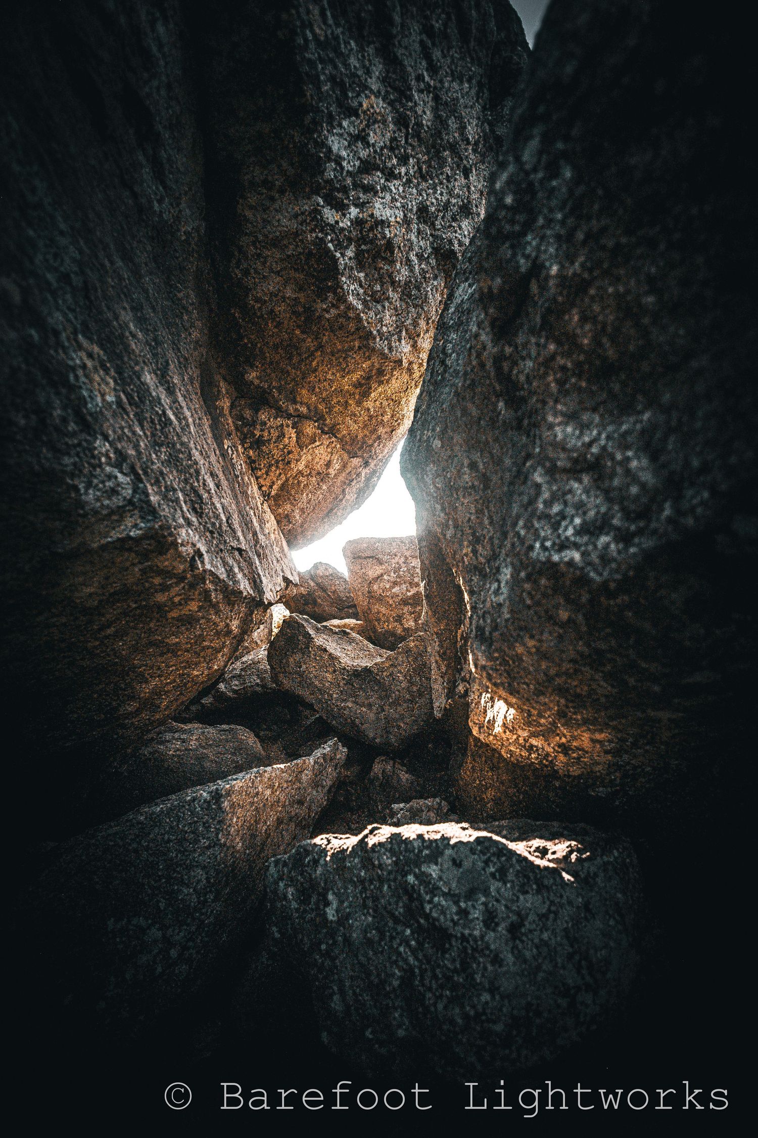 A photo at Arthur's rock in Colorado where the morning light shines through a few crevasses in the rock and stacked stone creating gorgeous