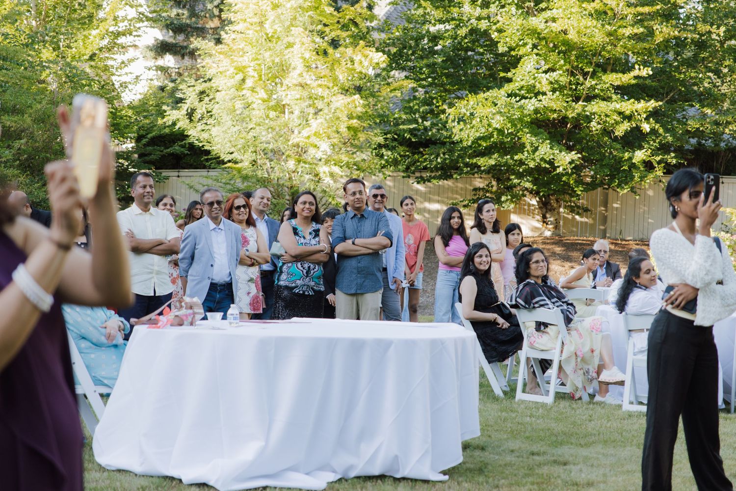 Guests gathered outdoors at a sunny garden celebration party event.