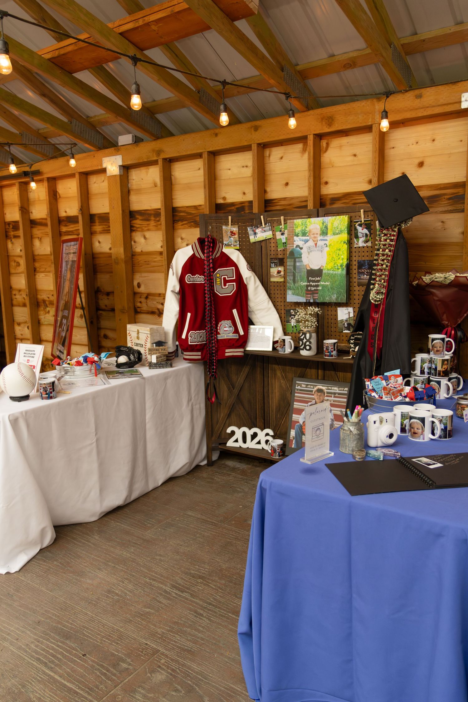 Graduation party display with varsity jacket, caps, mugs, and class of 2026 decor.