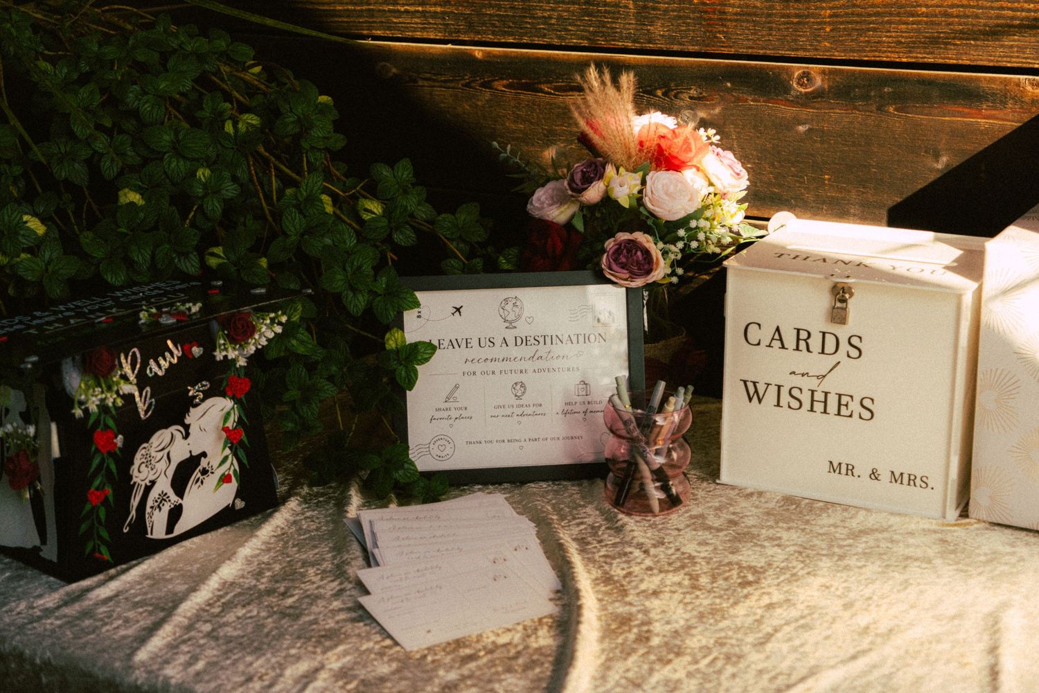 Wedding gift table with cards and wishes box, floral arrangement, and decorative items for Mr. and Mrs.