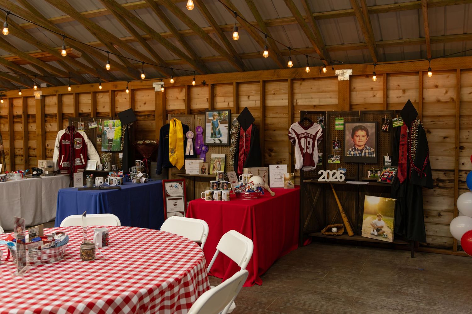 Indoor barn graduation party with sports memorabilia, jerseys, and class of 2026 display.