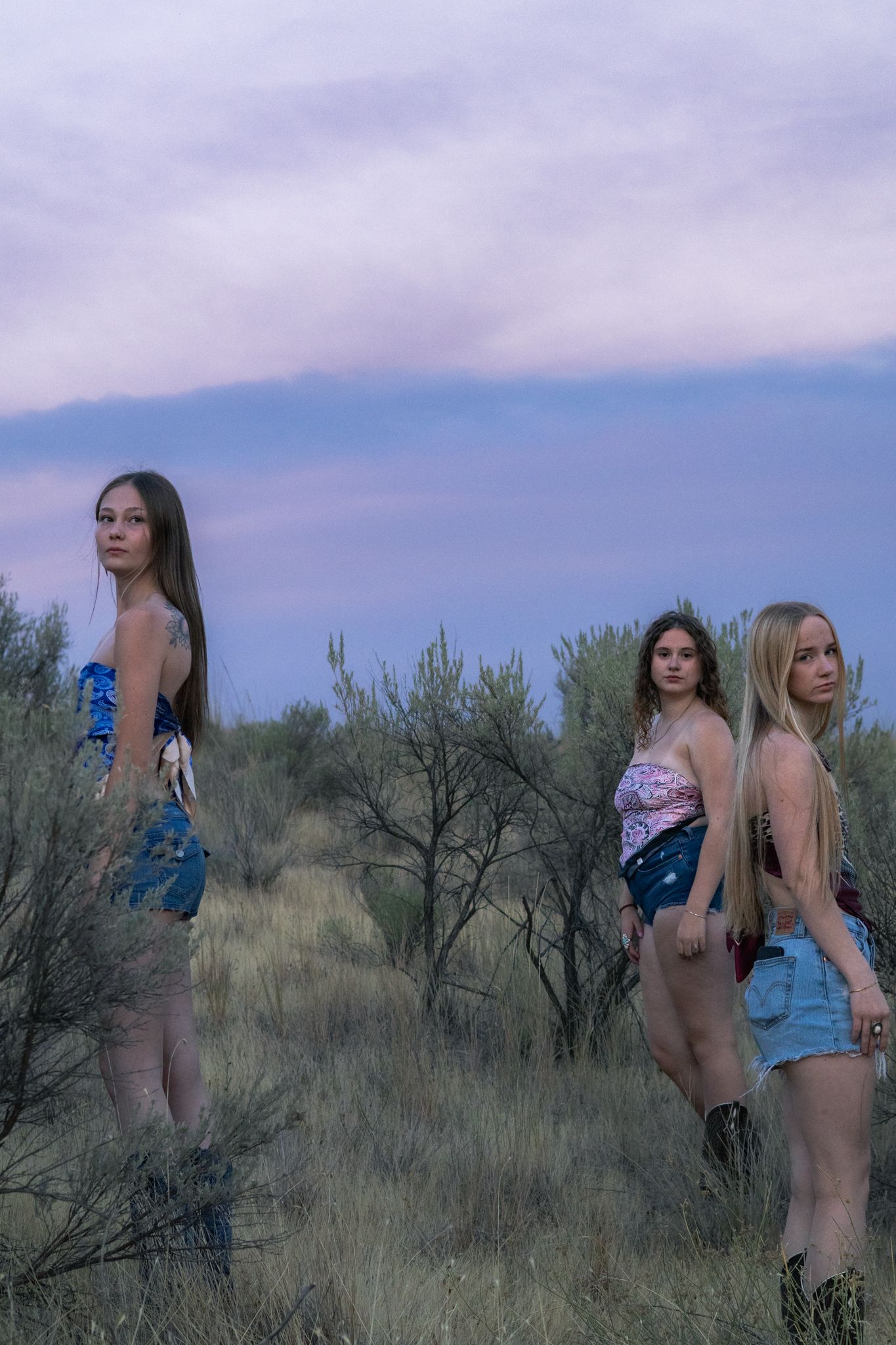 three girls stand in the high desert and pose longingly and dramatically for this clothing campaign, as well as a senior portrait session.