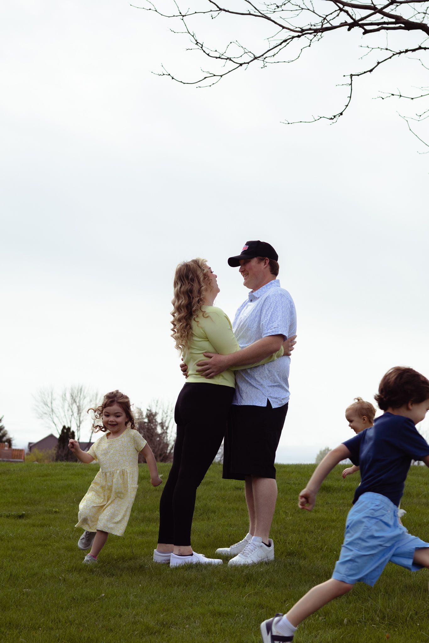 Outdoor family photoshoots with children playing around their parents.