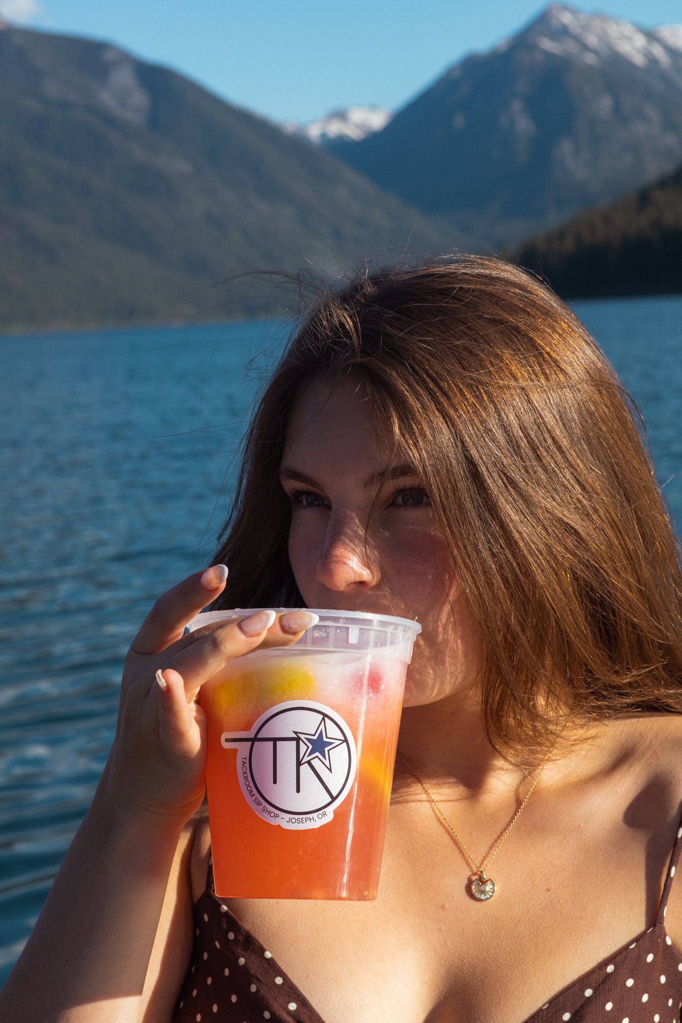A woman gazes over Wallowa Lake while sipping on a lemonade in this coffee product campaign.