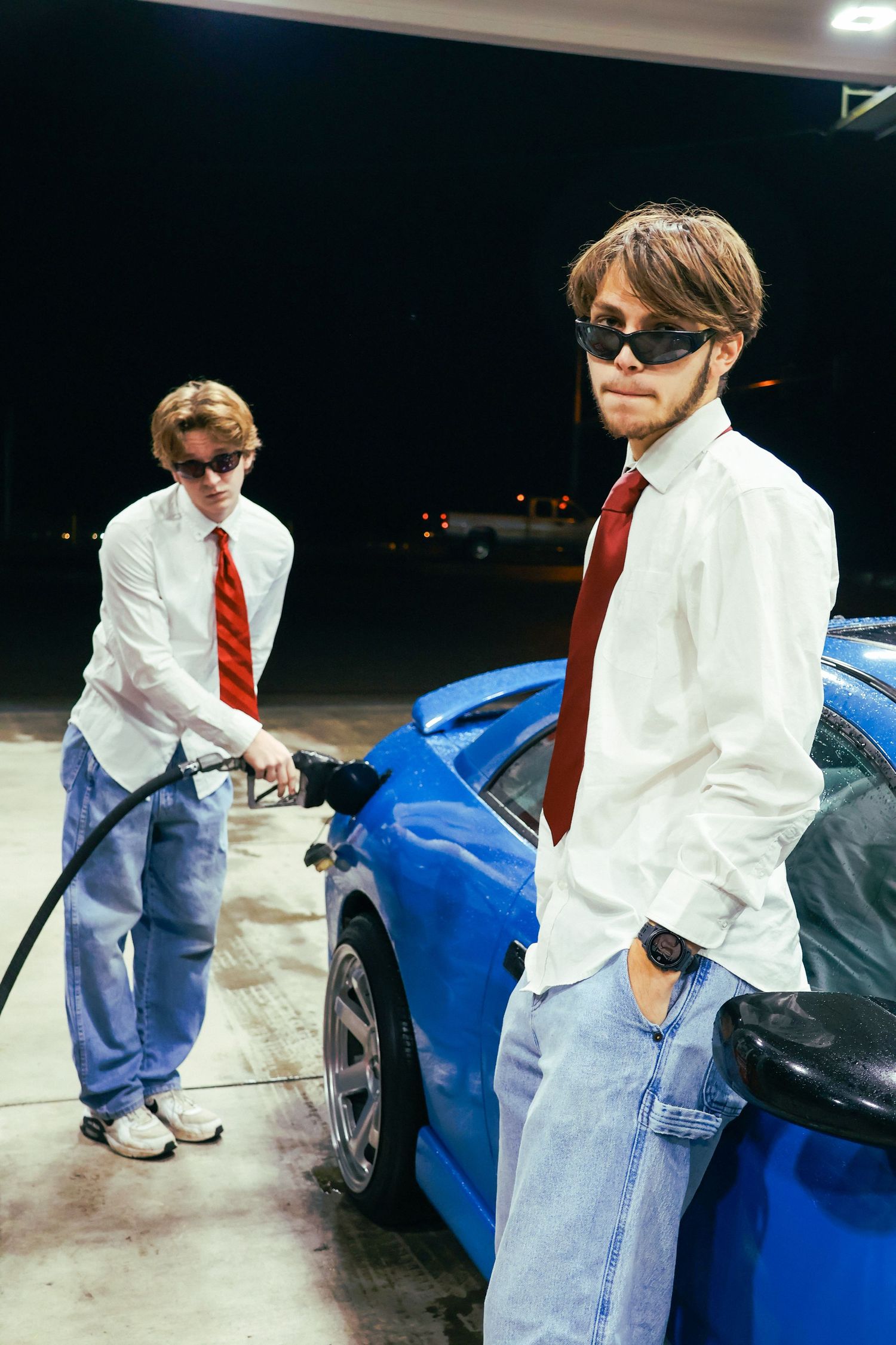 Two men pose besides a Mitsubishi Eclipse in this Y2K inspired gas station photoshoot.