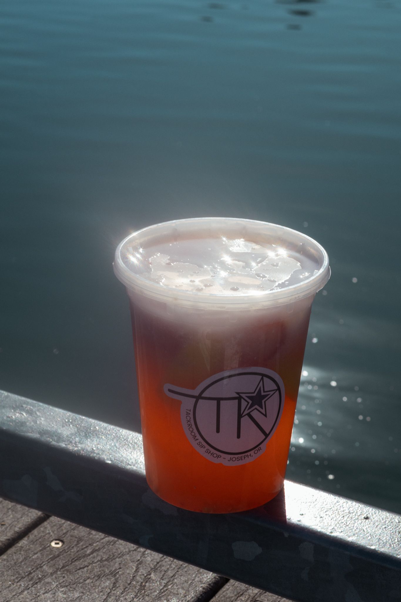 A shiny drink sits on the lake dock in this coffee product campaign.