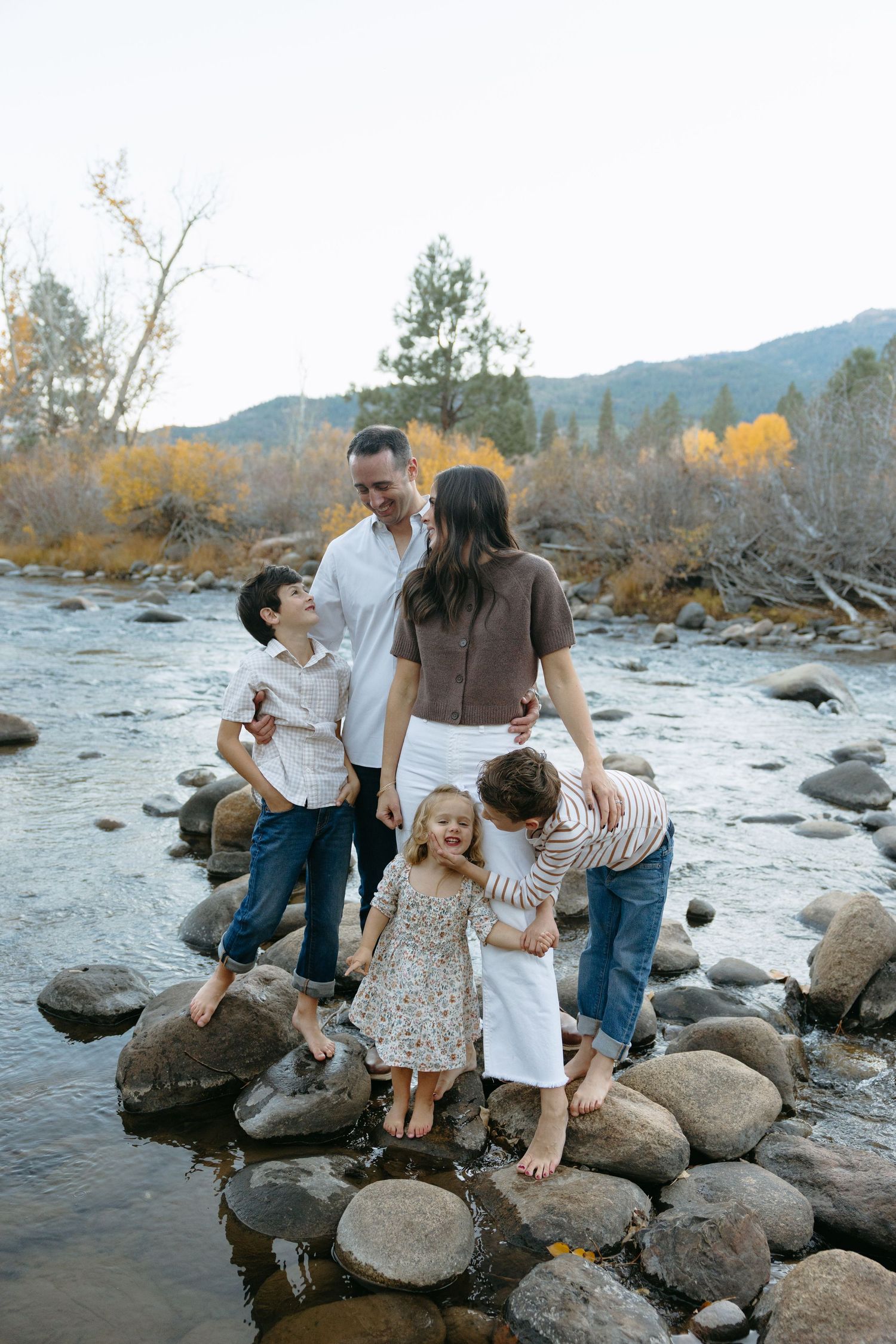 family laughing by the river