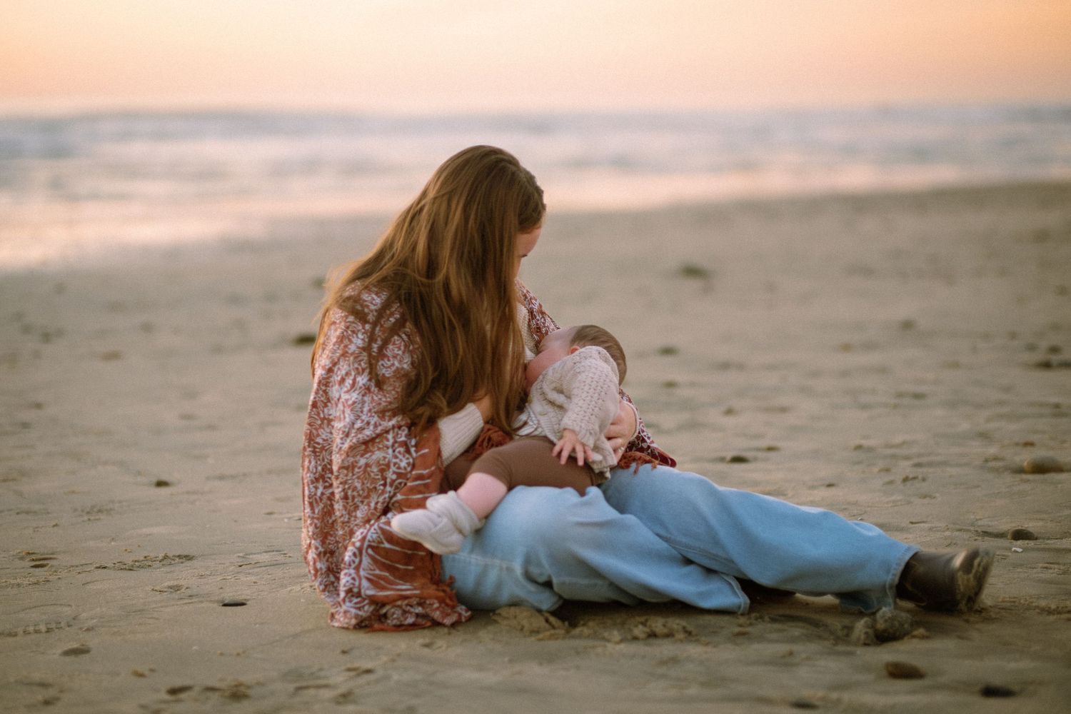 woman breastfeeding on the beach