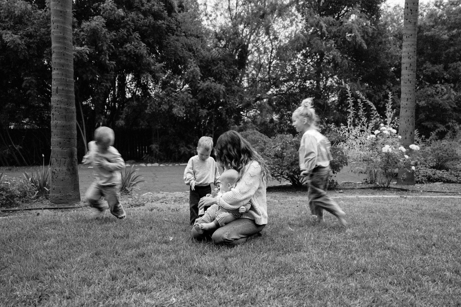 mother and her children running around her