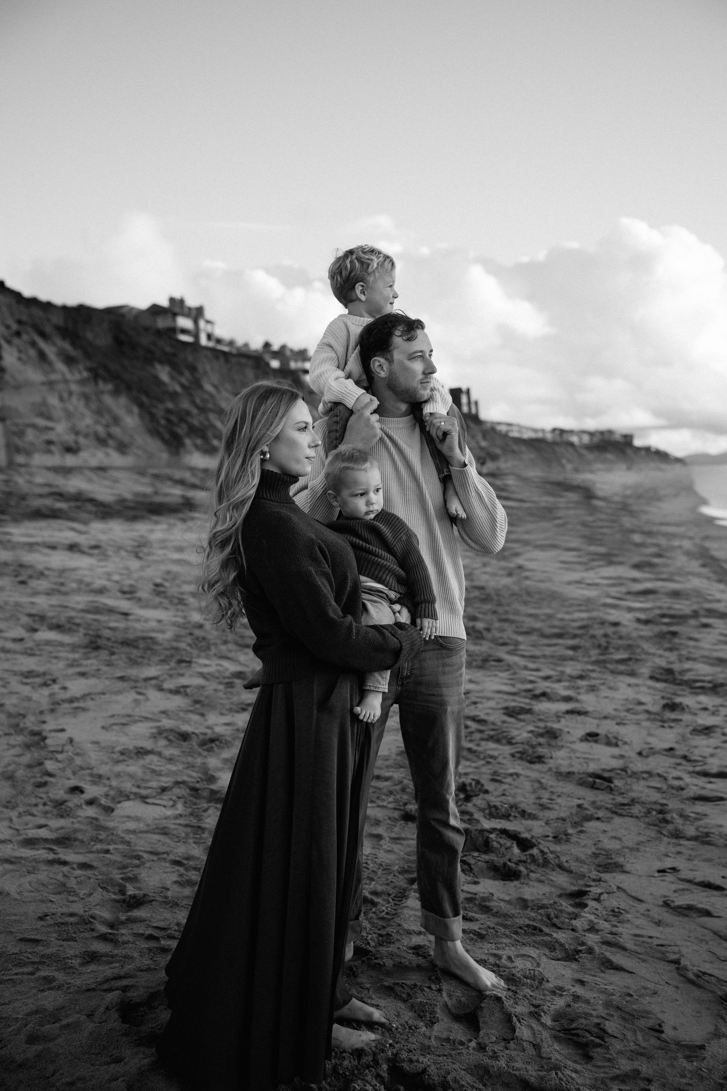 family looking out into the ocean at the beach