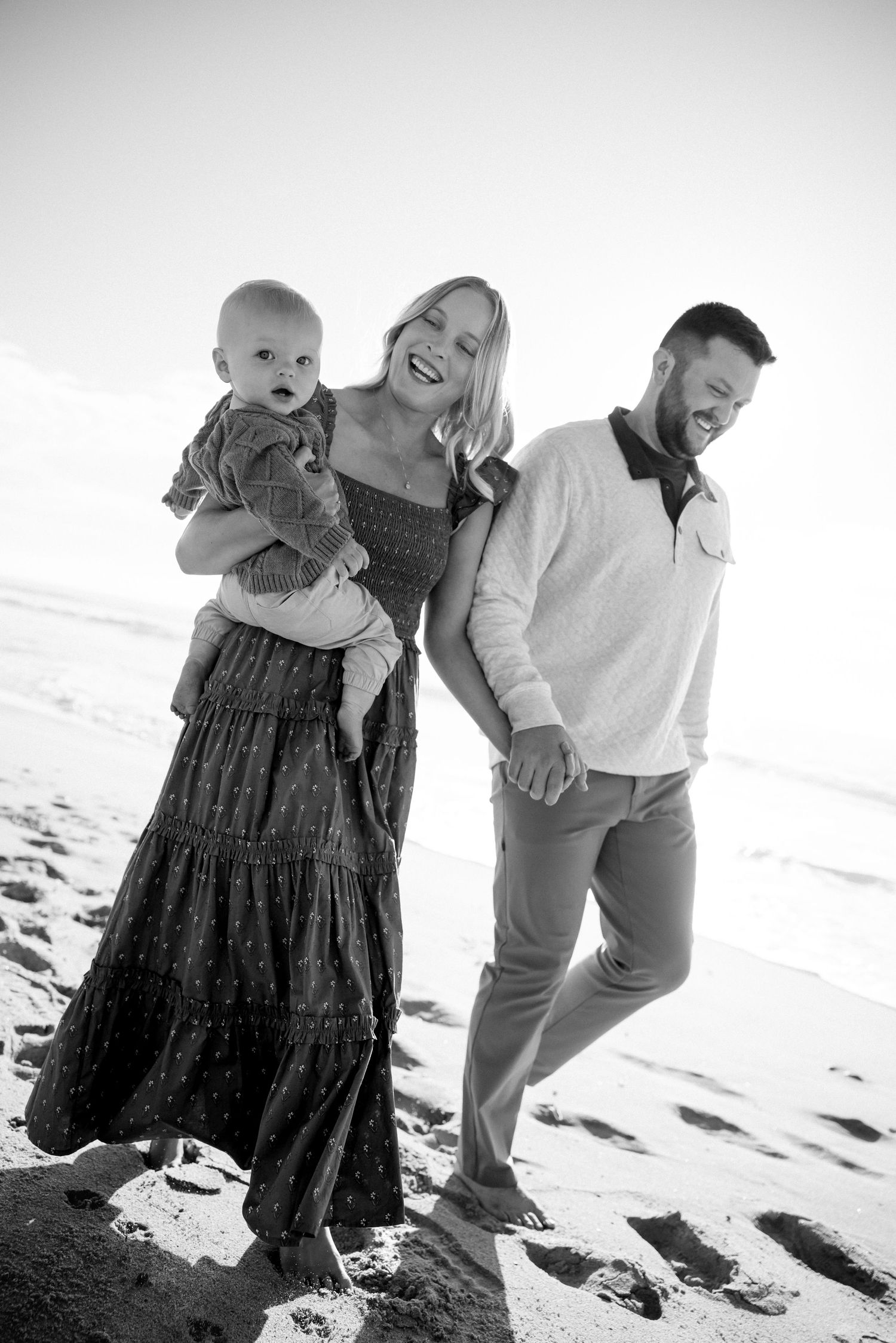 family holding hands at the beach