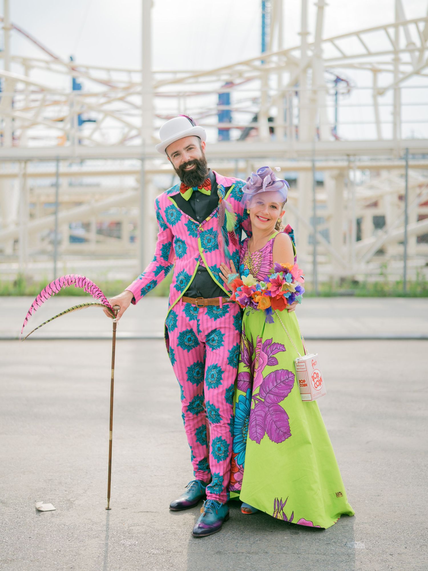Playful dance performance against an amusement park backdrop with bright floral costumes.