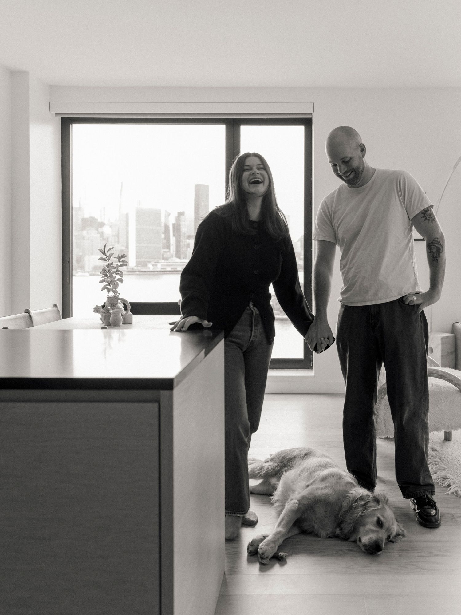 Black and white sequence showing people and dog in modern interior space.