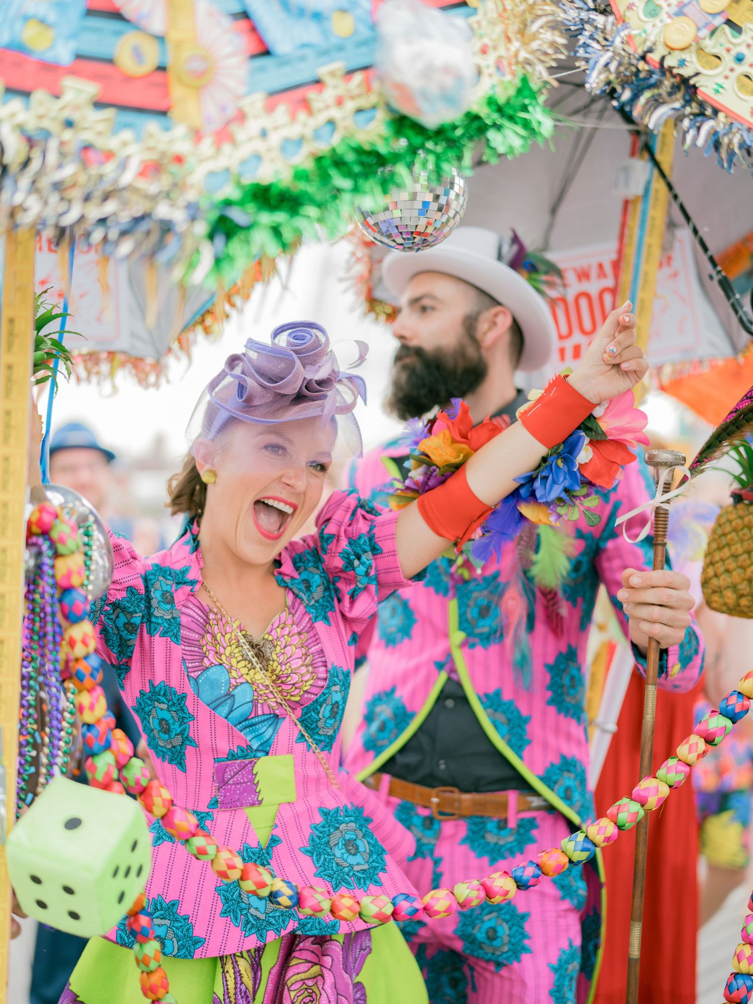 Colorful festival celebration with bright decorations and vibrant tropical-print costumes.
