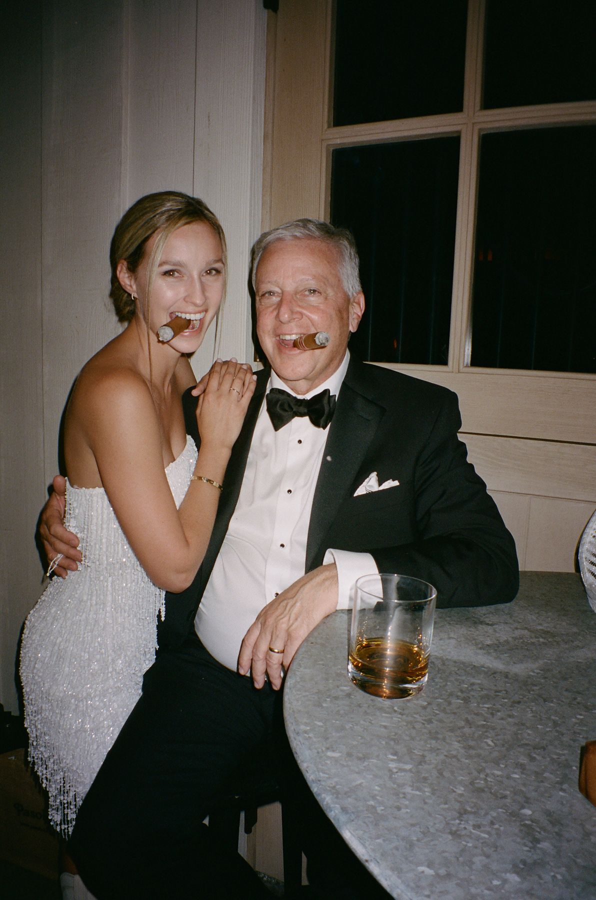 Formal party scene at a table with drinks and evening attire.