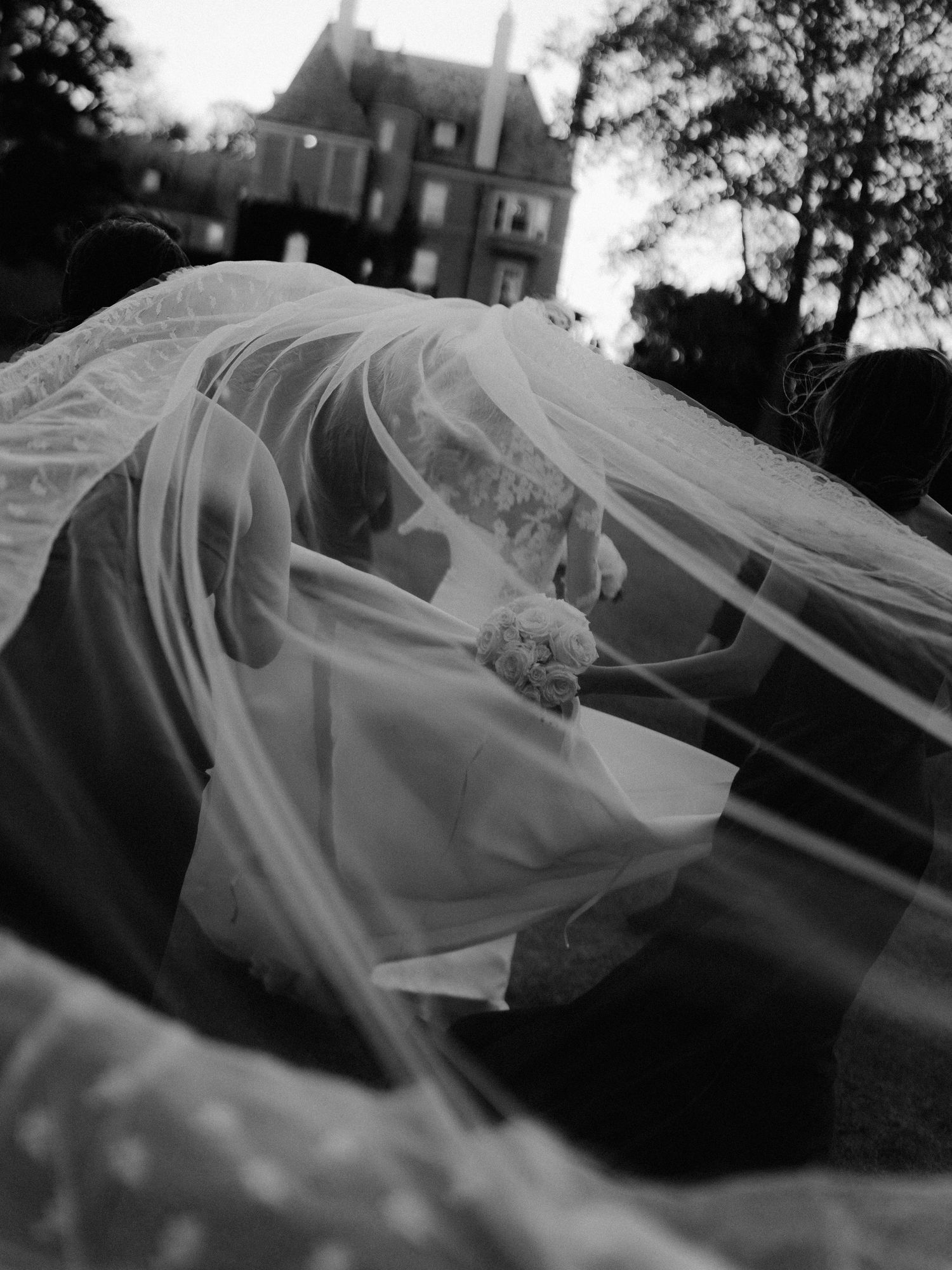 Flowing white bridal veil captured in dramatic black and white photography.