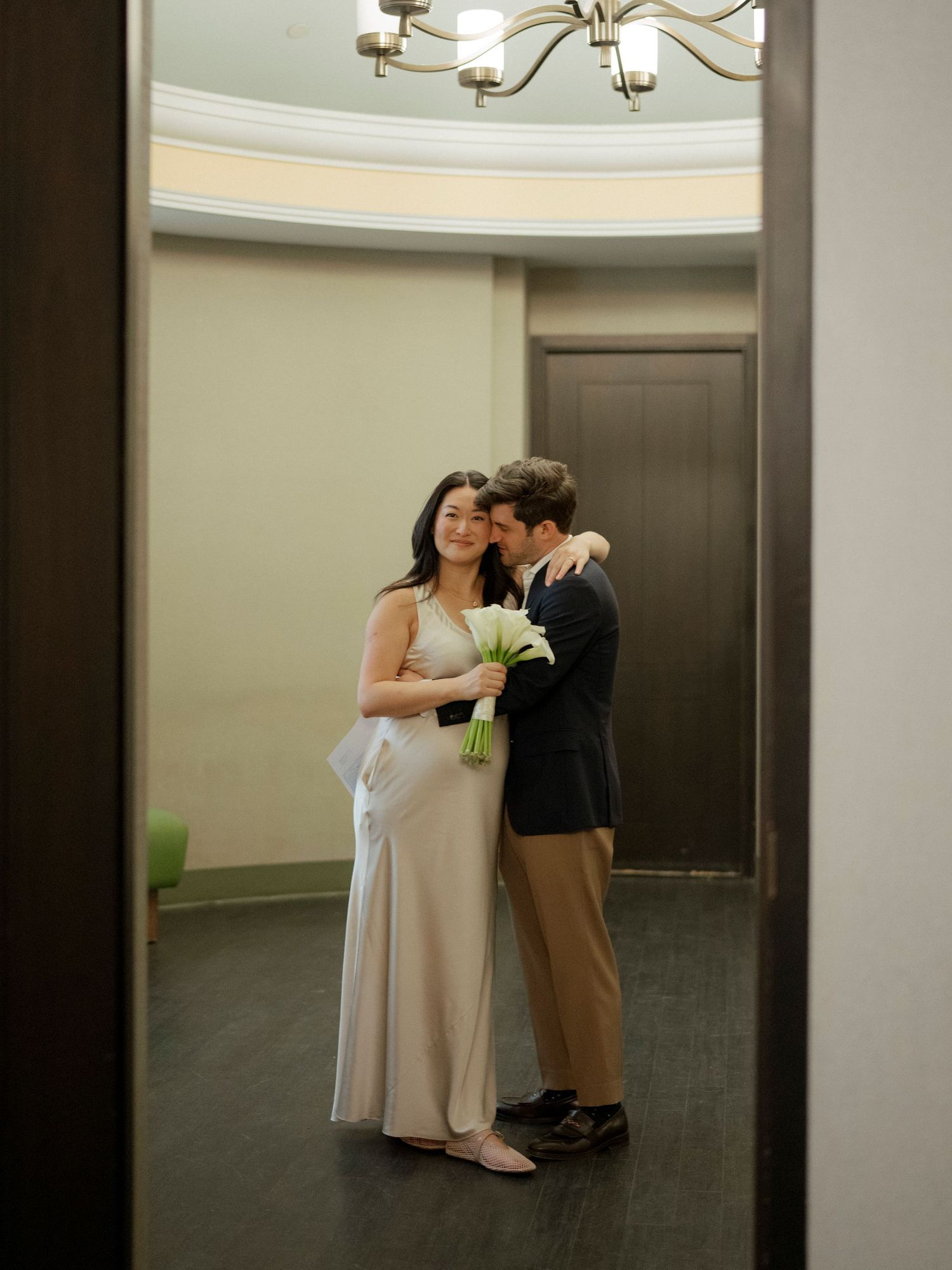 A sequence of intimate moments captured in an elevator with modern lighting and reflective walls.
