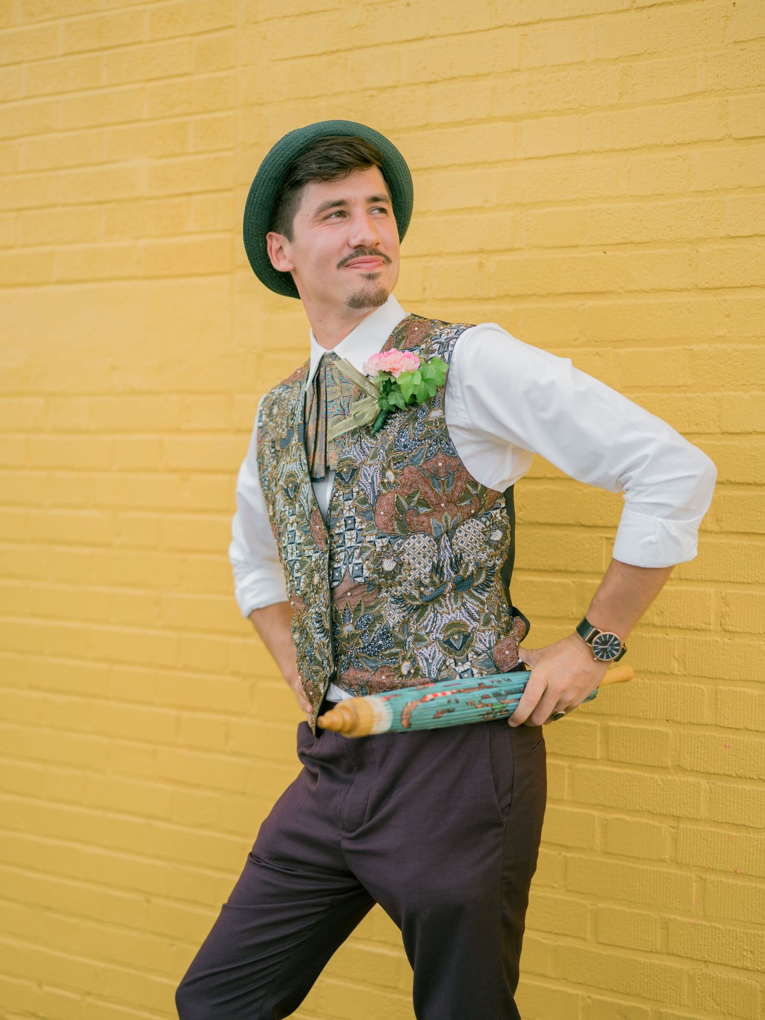 Vintage-inspired poses against yellow wall showing detailed vest and period costume.