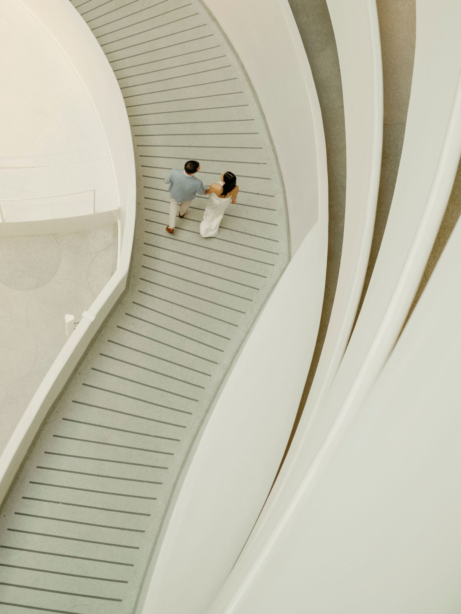 Modern white curved architectural interior with minimalist design and flowing lines.