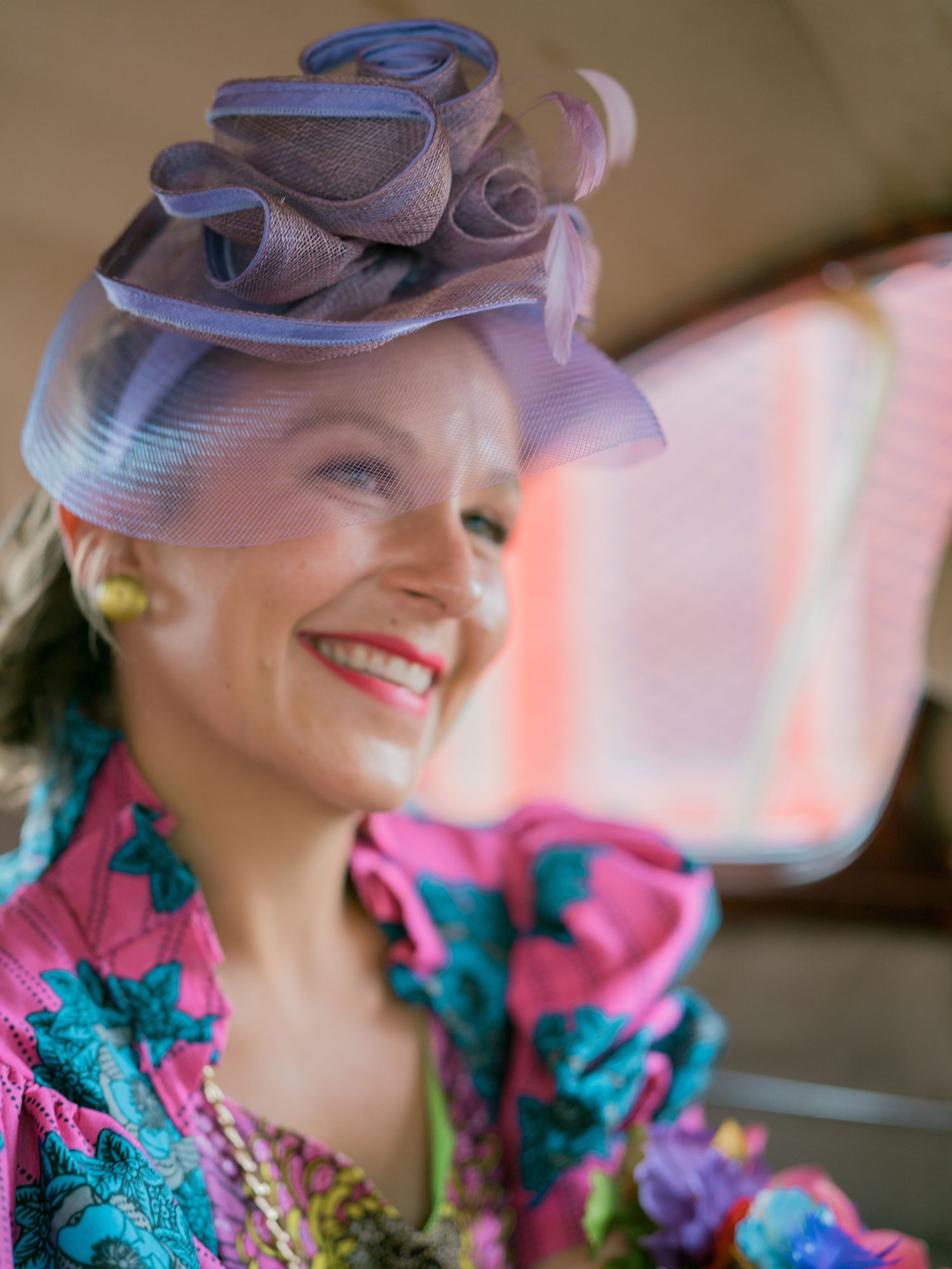 Retro-styled portrait featuring a blue hat and vibrant floral costume details.