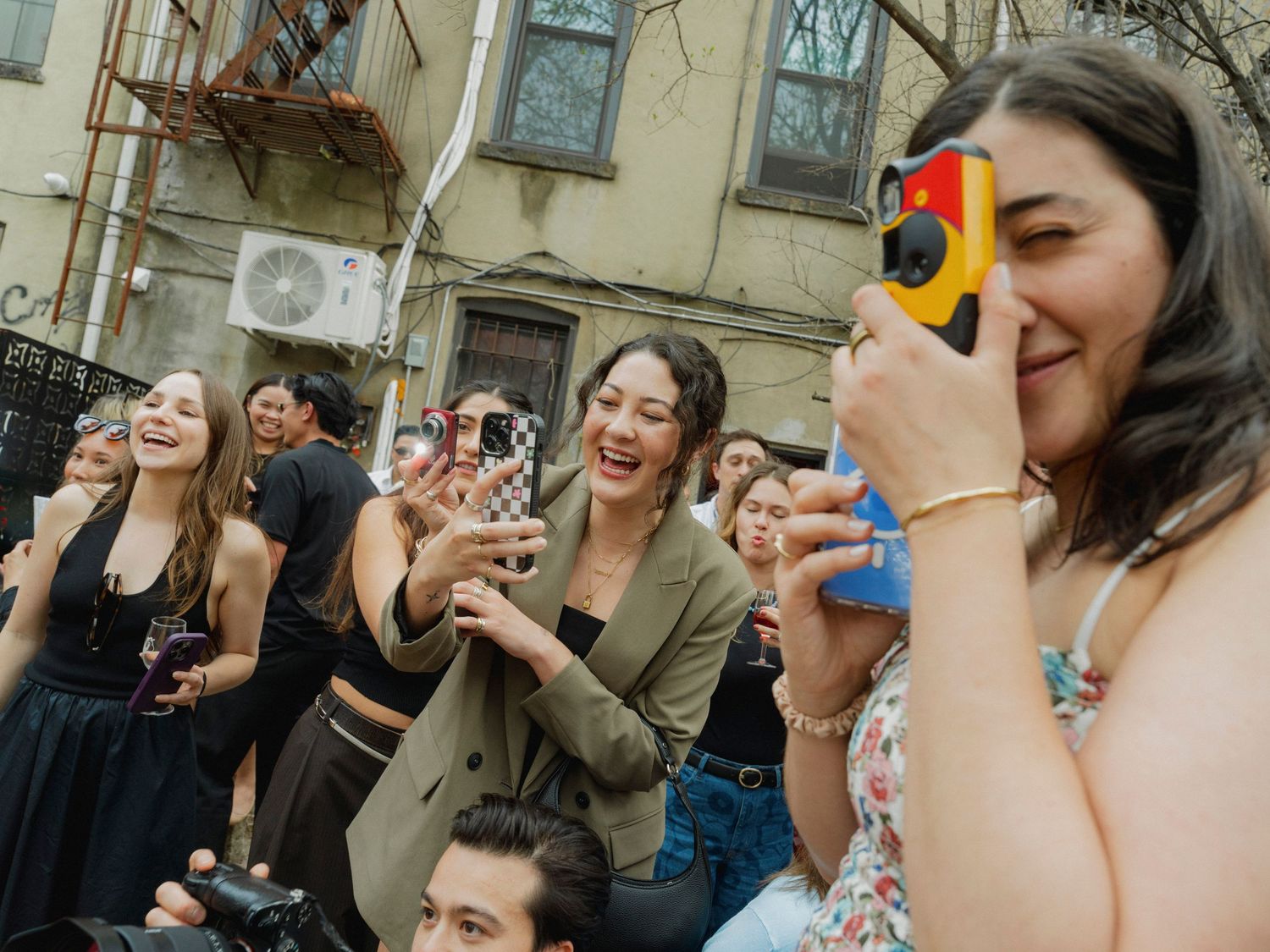 A lively party gathering with people enjoying drinks and laughing together.