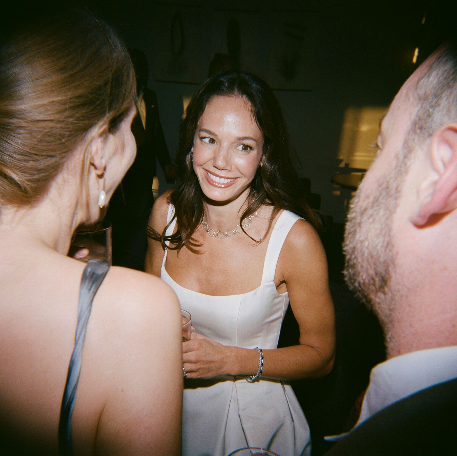 Intimate dance floor moments captured in low light at an evening reception.