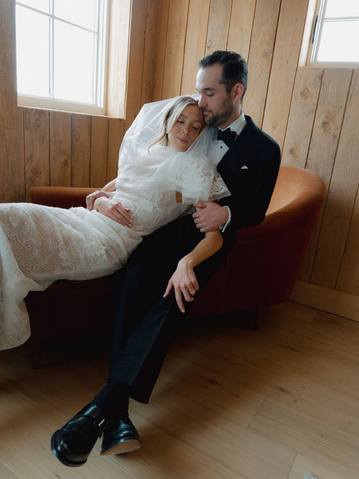 A series of artistic black and white wedding photos showing intimate moments in a wood-paneled room.