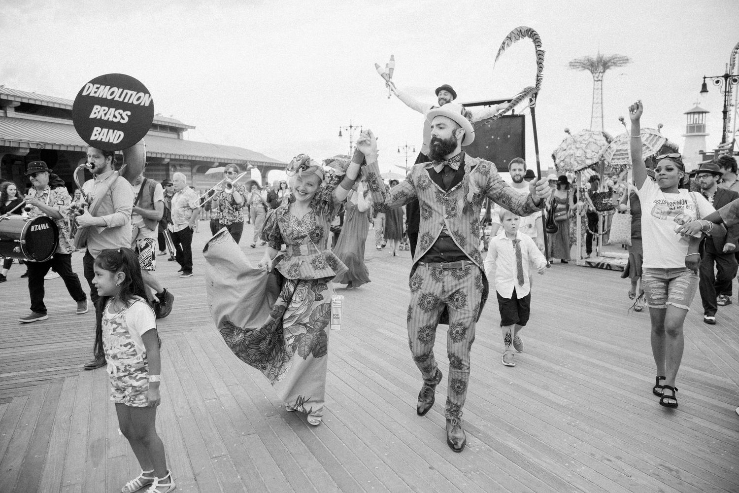 Black and white panorama of dancers performing on Coney Island boardwalk.